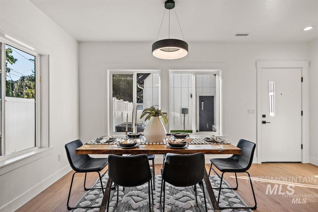 Dining area with light wood-style floors and baseboards