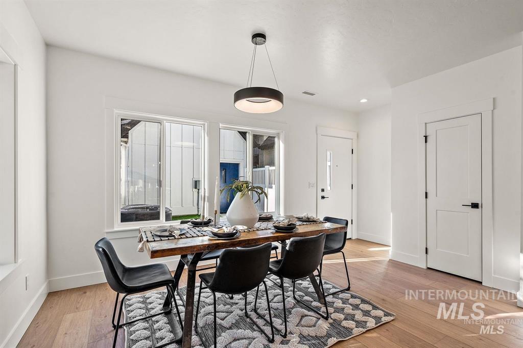 Dining room featuring light wood-style floors and baseboards