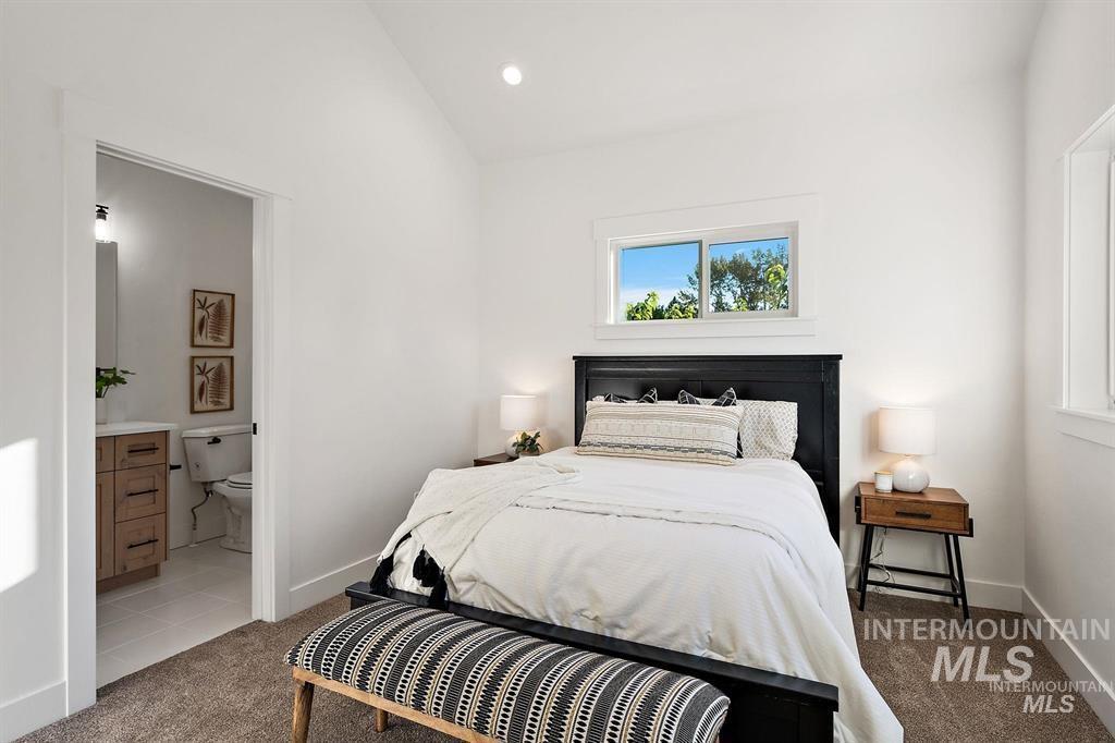 Bedroom with carpet, vaulted ceiling, ensuite bathroom, and recessed lighting