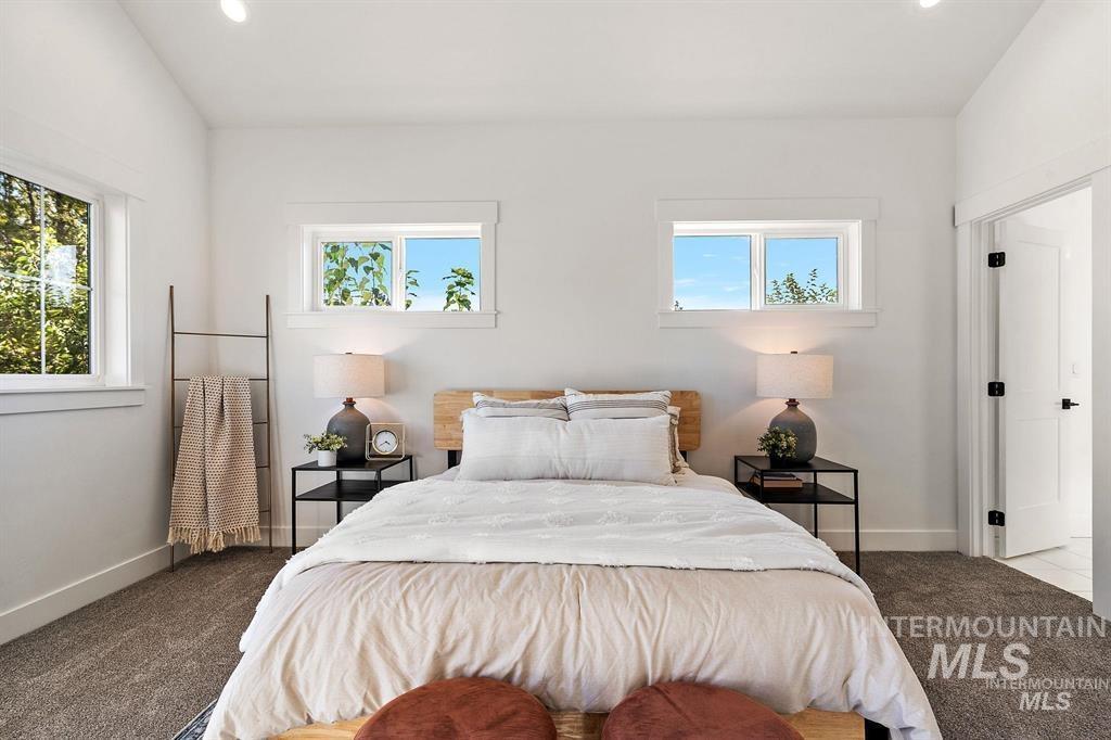 Bedroom featuring carpet floors, recessed lighting, and lofted ceiling