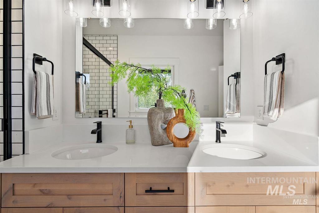 Bathroom with double vanity and a stall shower