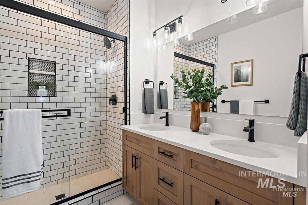 Bathroom with a stall shower and double vanity