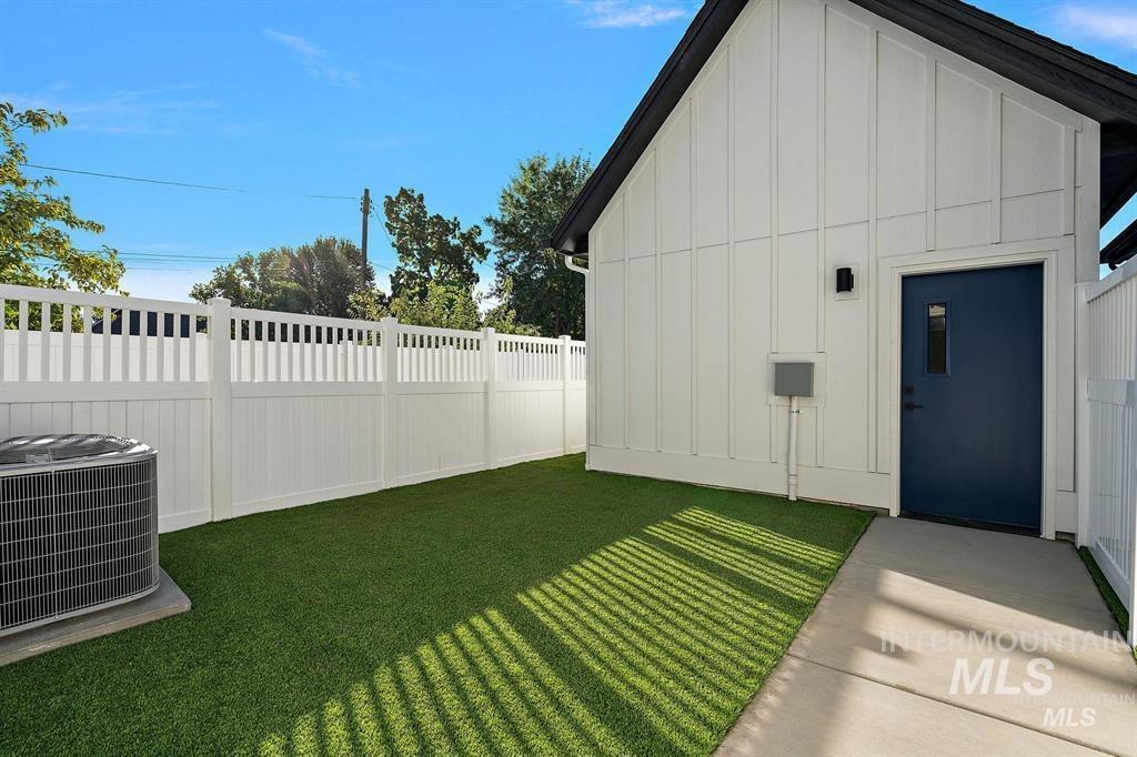 View of side of property with board and batten siding and a central air condition unit