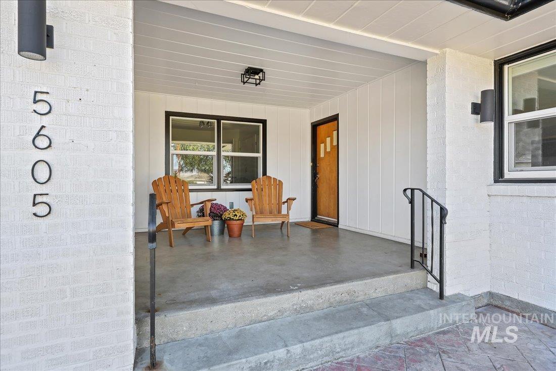 Doorway to property with covered porch