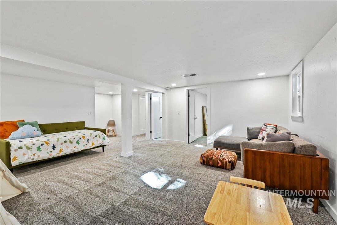 Living area with carpet flooring and recessed lighting