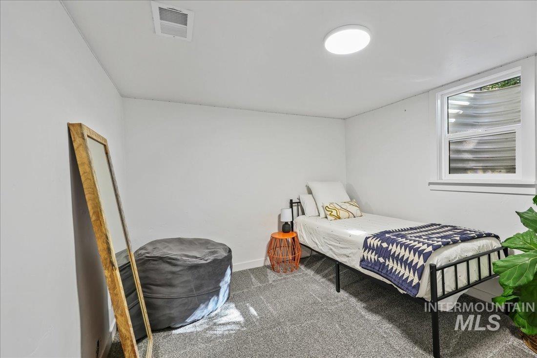 Bedroom featuring carpet and baseboards