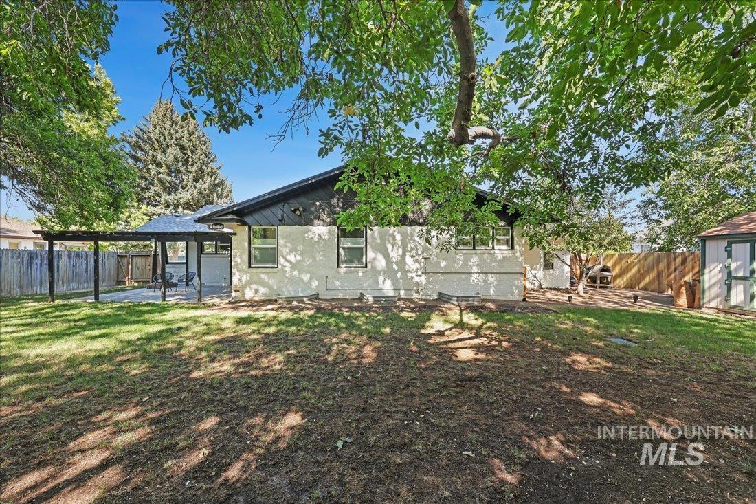 Rear view of property featuring a fenced backyard and a patio area