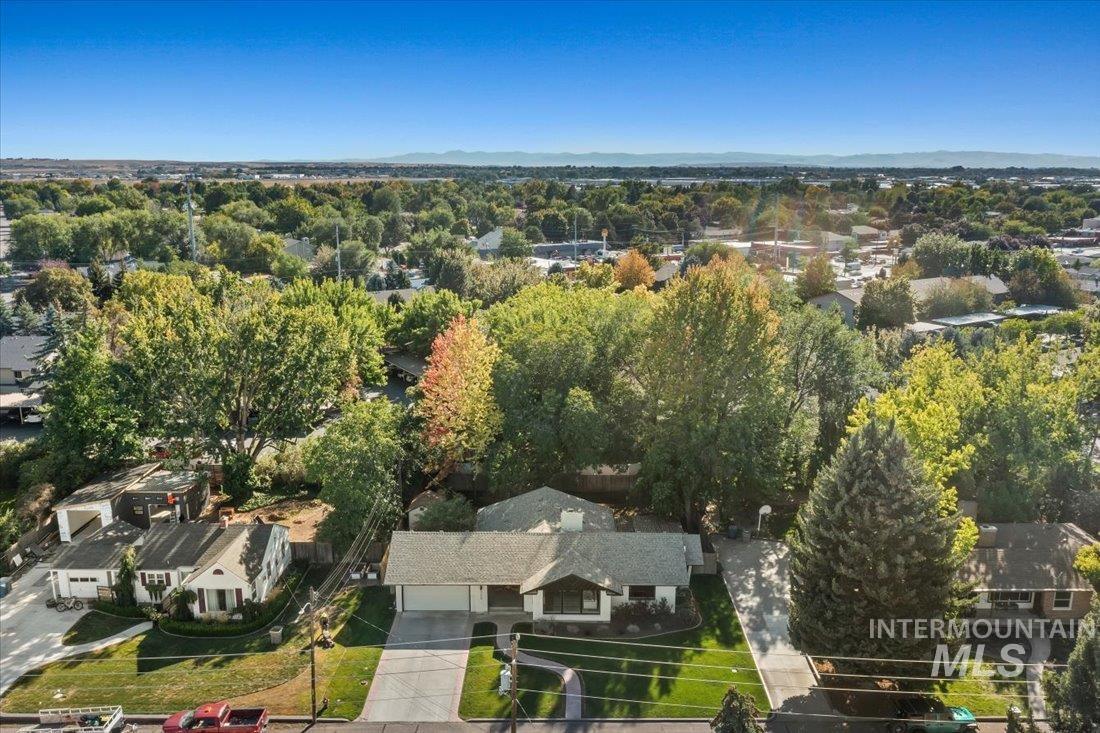 Aerial view of property's location featuring nearby suburban area and a mountain backdrop