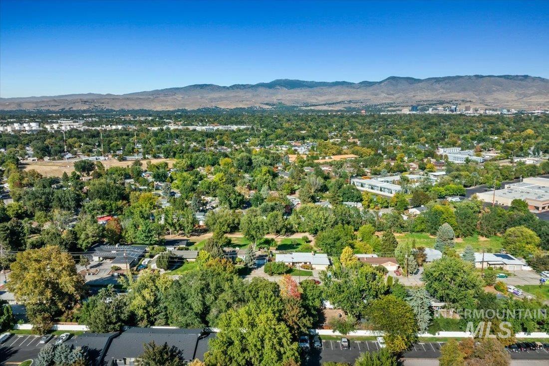 View of property location featuring a mountain backdrop and a tree filled landscape