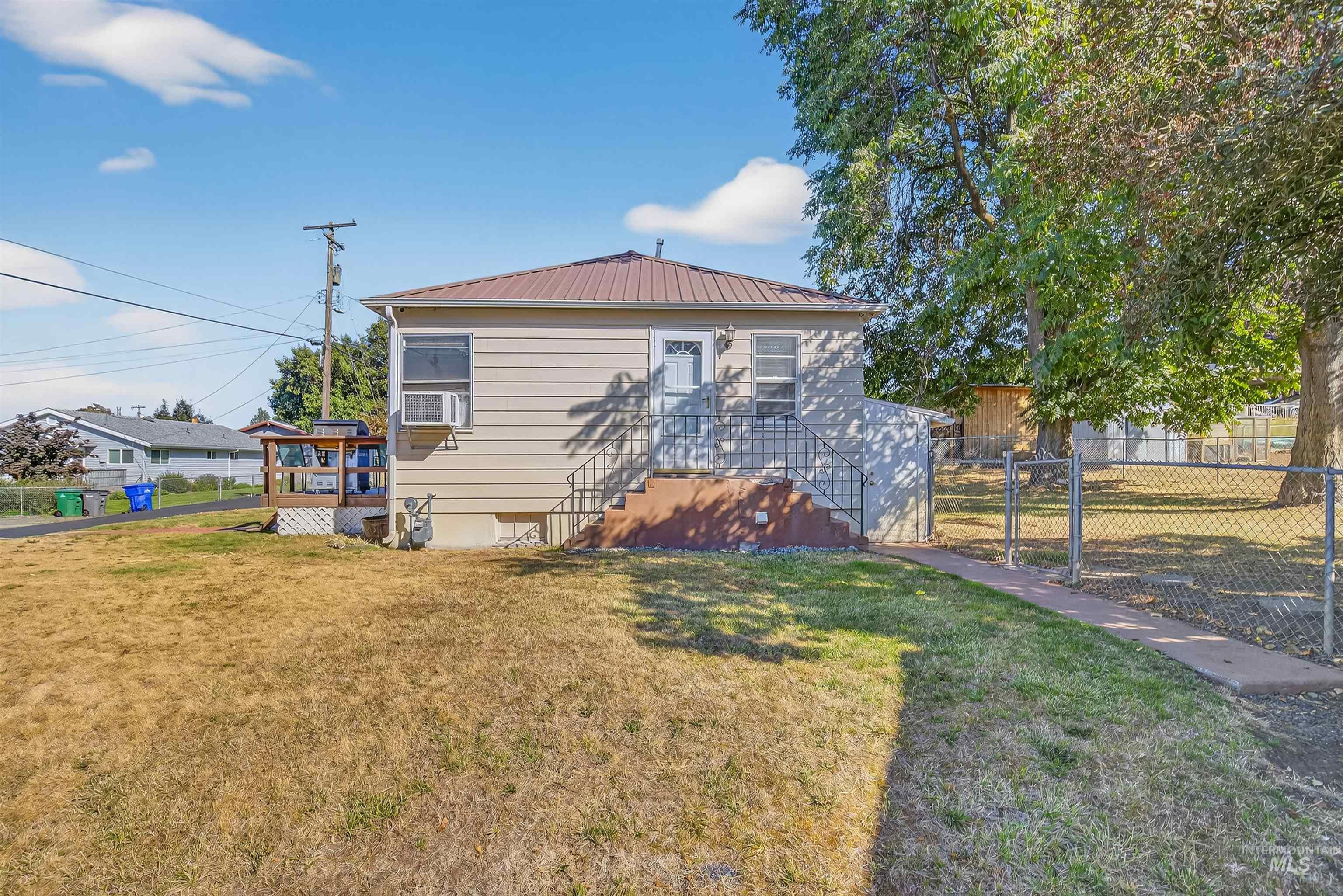 Back of house with a metal roof