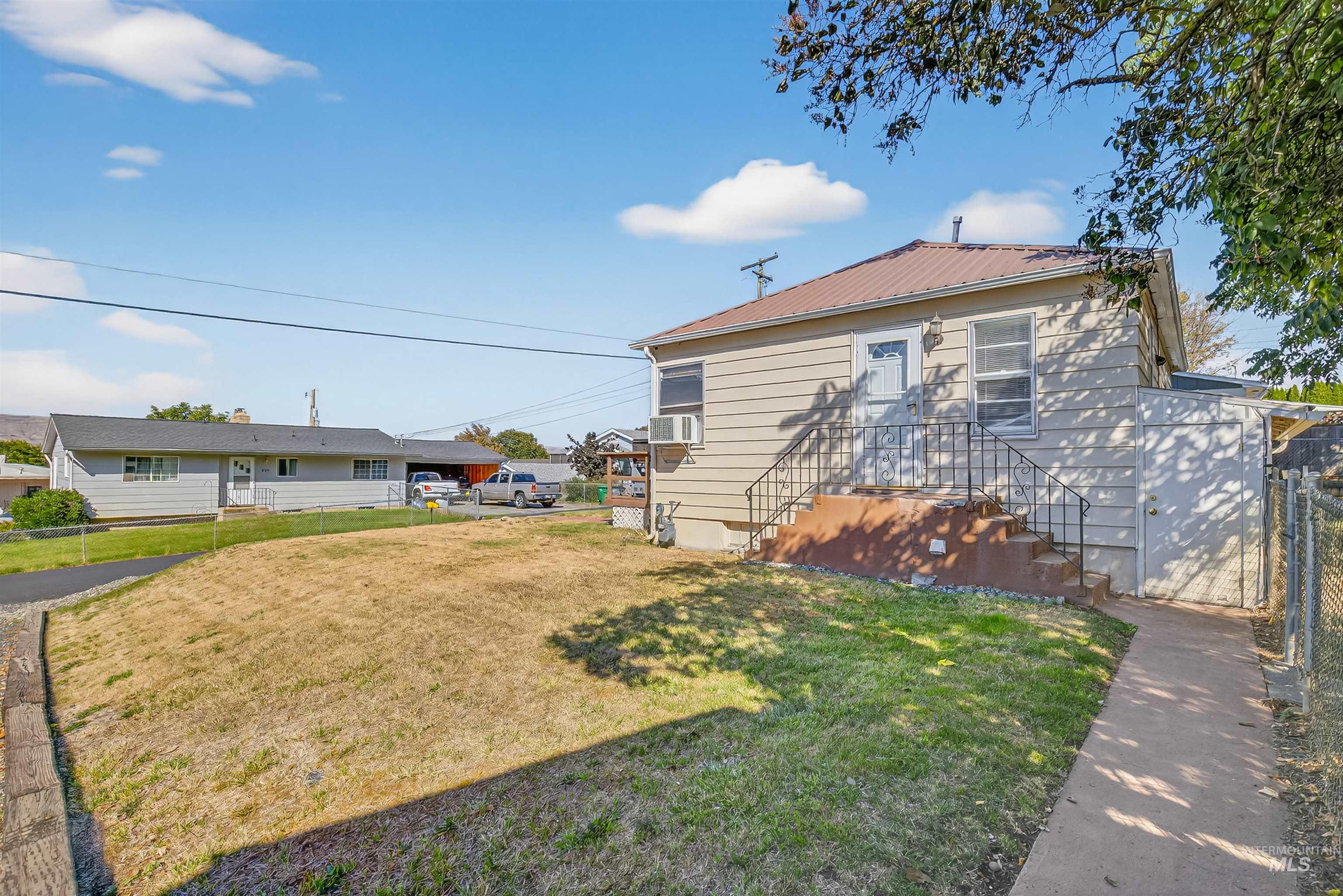 Back of property with a metal roof