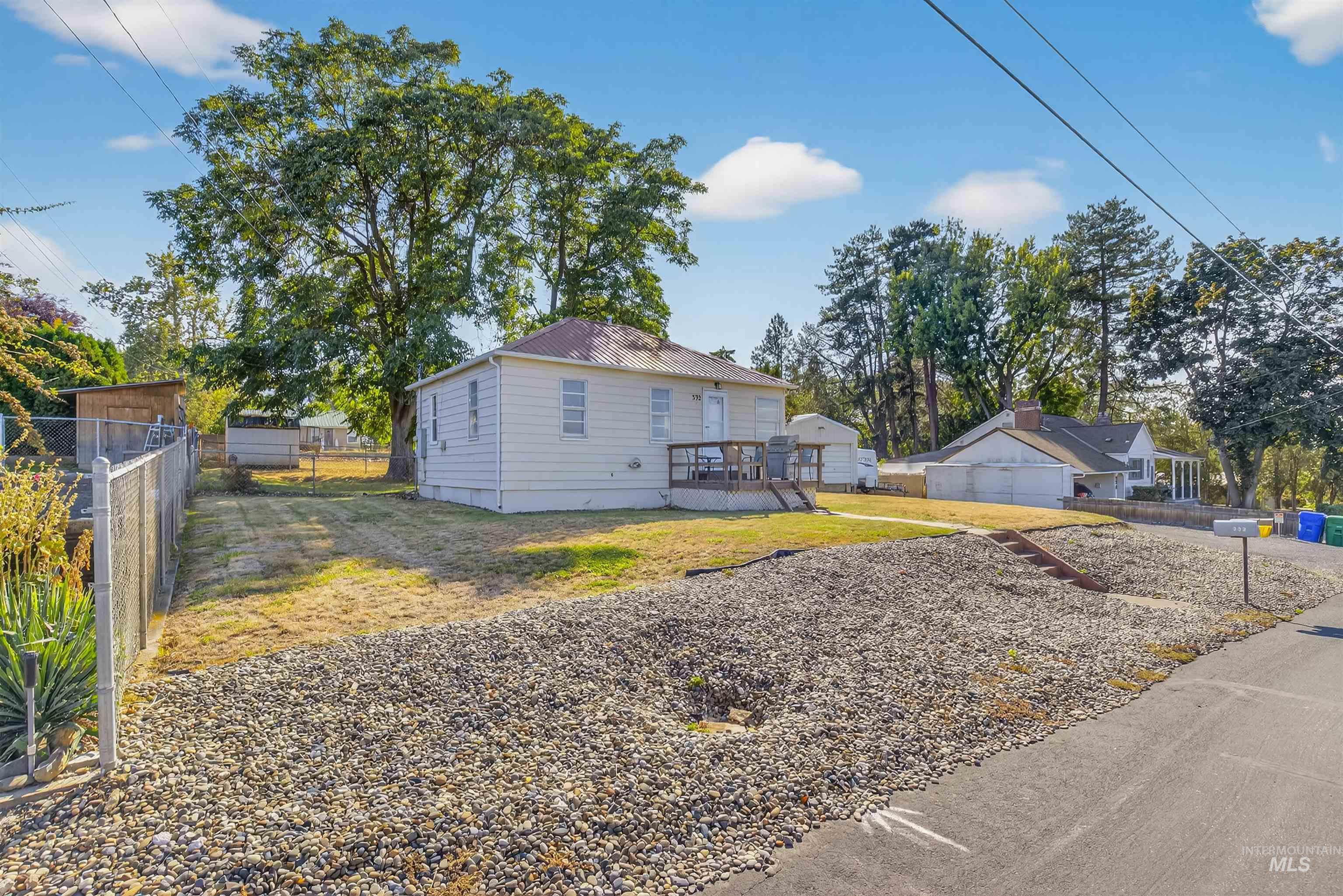 View of front of property with a wooden deck and a metal roof