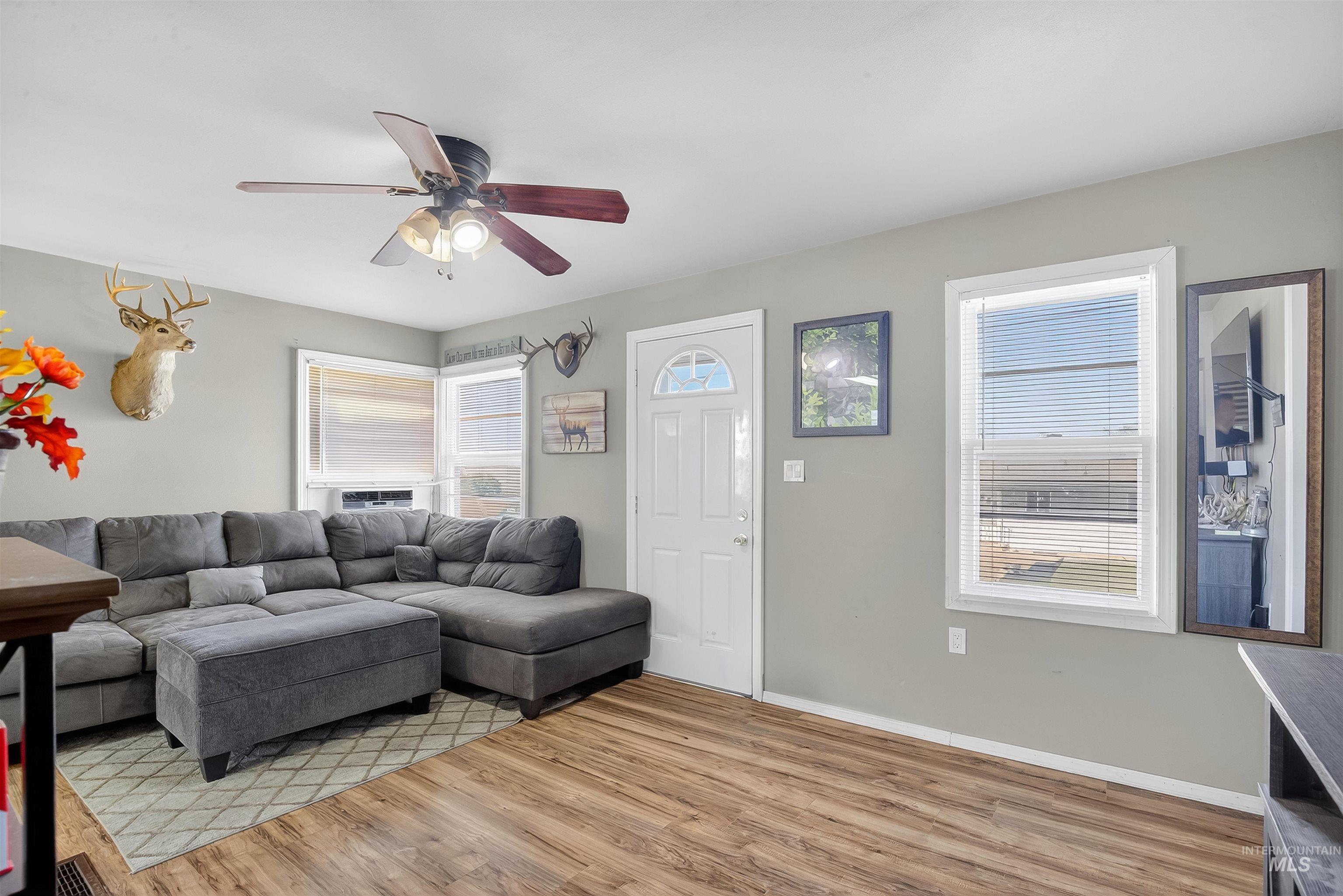 Living room featuring light wood-style floors and ceiling fan