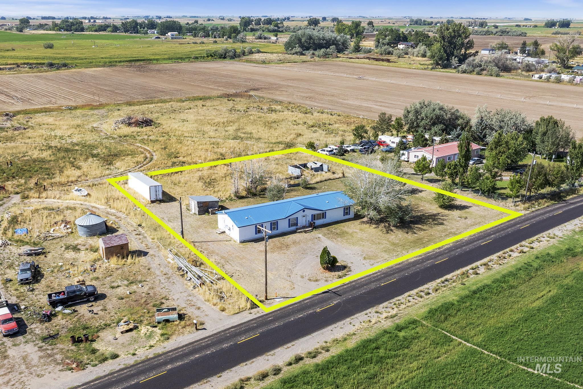 Aerial view of sparsely populated area with property parcel outlined