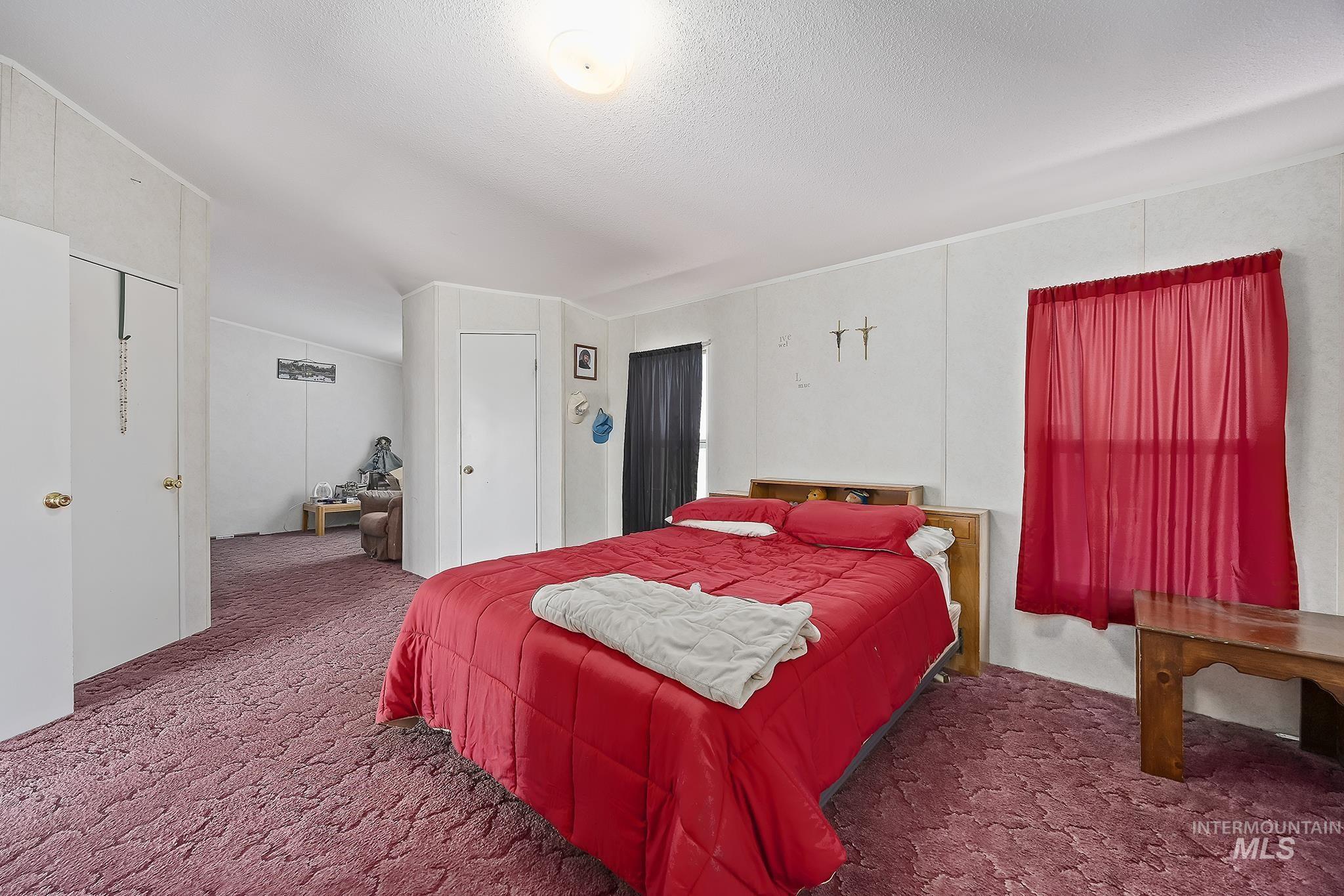 Carpeted bedroom with a textured ceiling