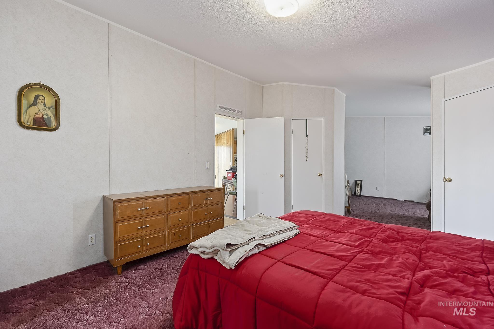 Bedroom featuring dark carpet
