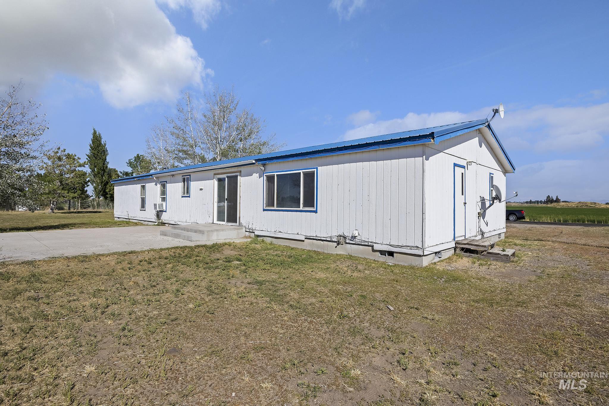 View of front of home featuring crawl space, a metal roof, and a front lawn