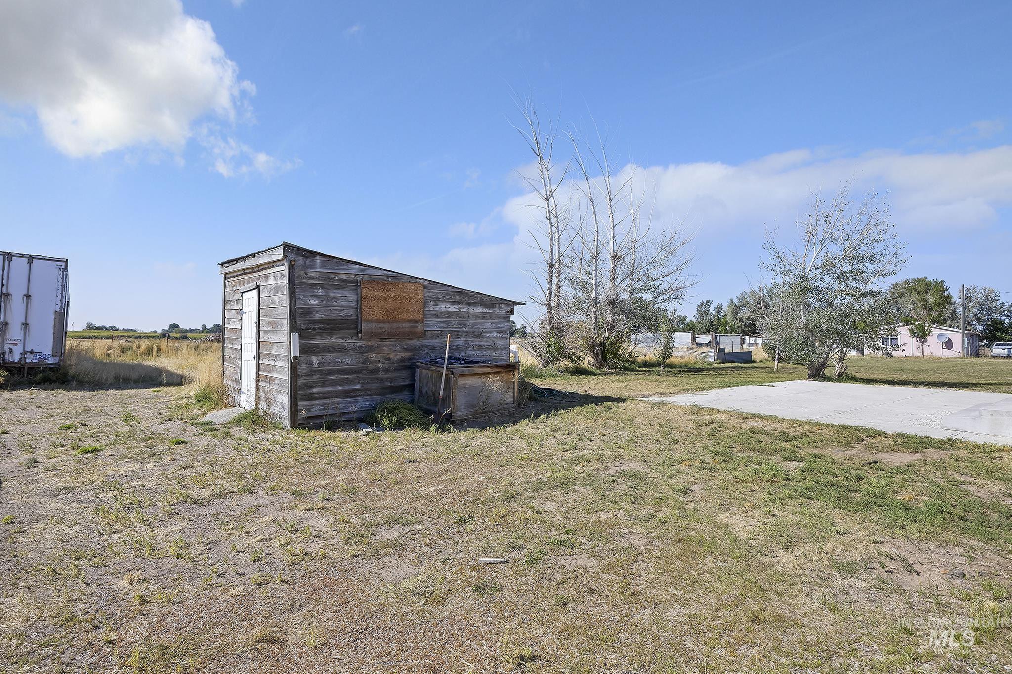 View of grassy yard with an outbuilding