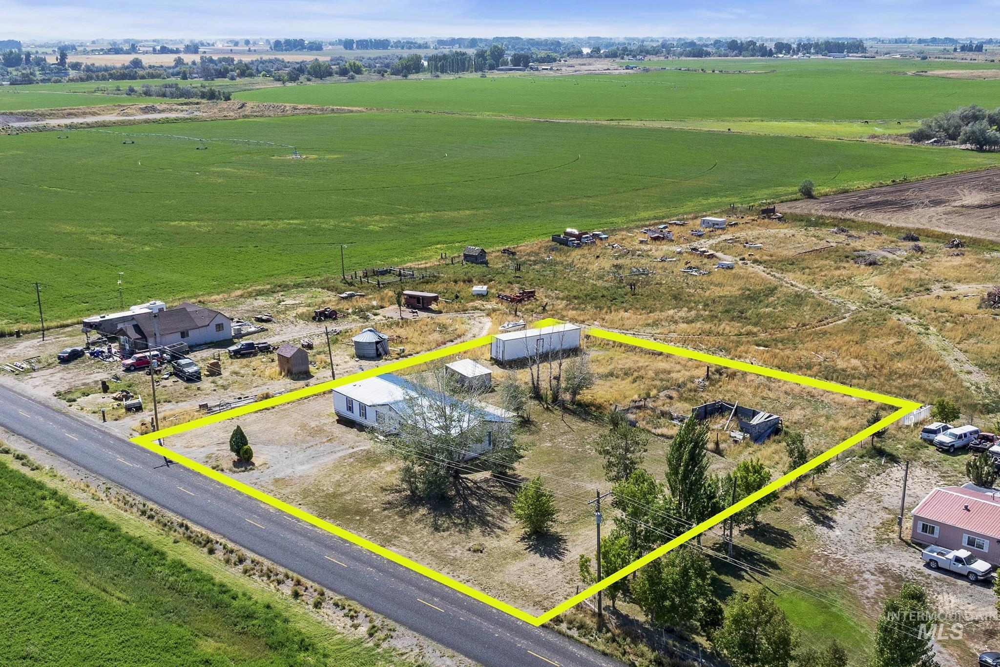 Aerial view of sparsely populated area featuring property boundaries highlighted