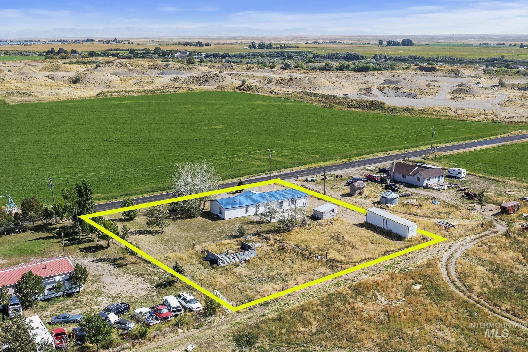 Aerial view of sparsely populated area with property parcel outlined