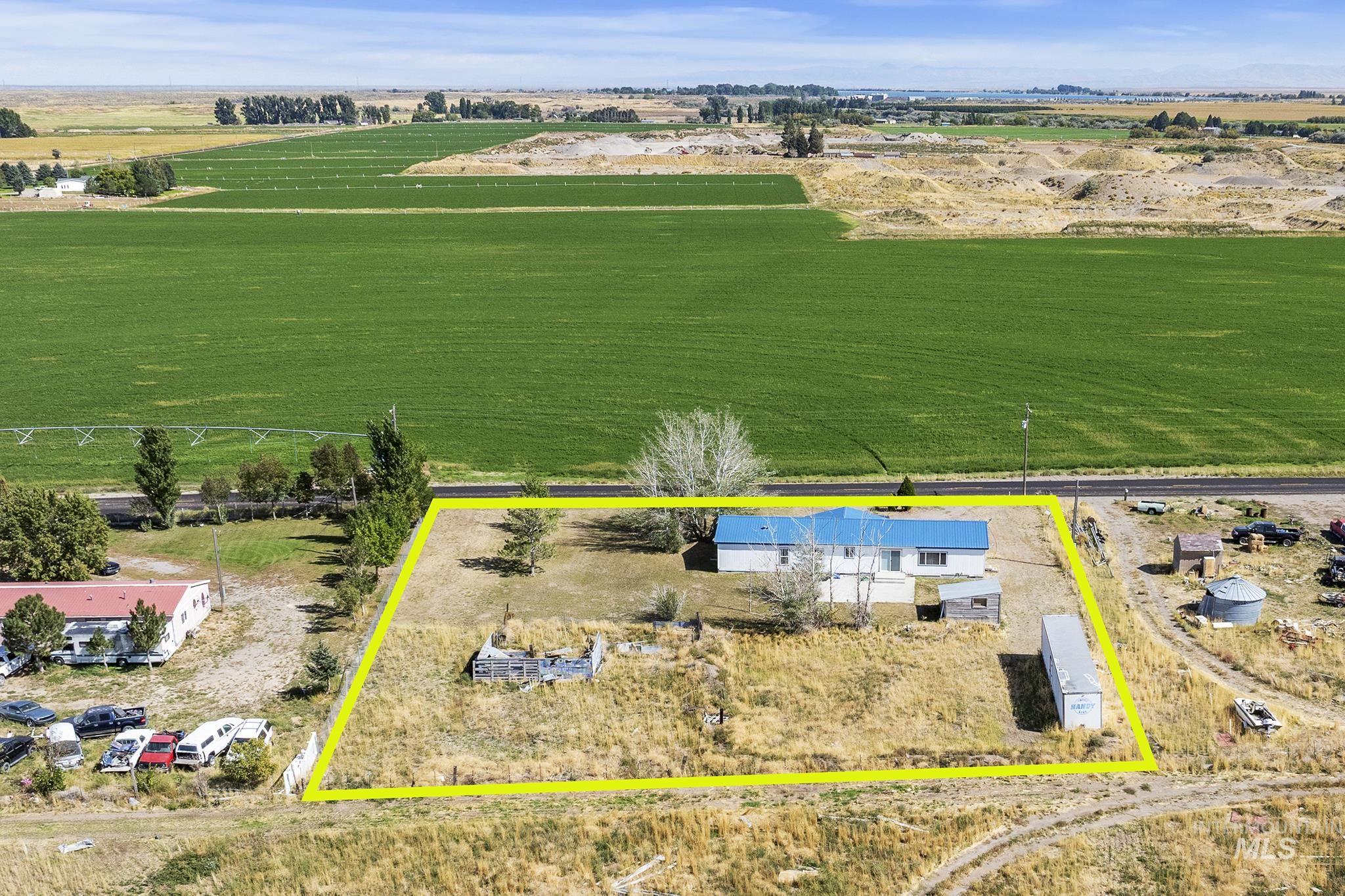 Aerial view of sparsely populated area with property parcel outlined