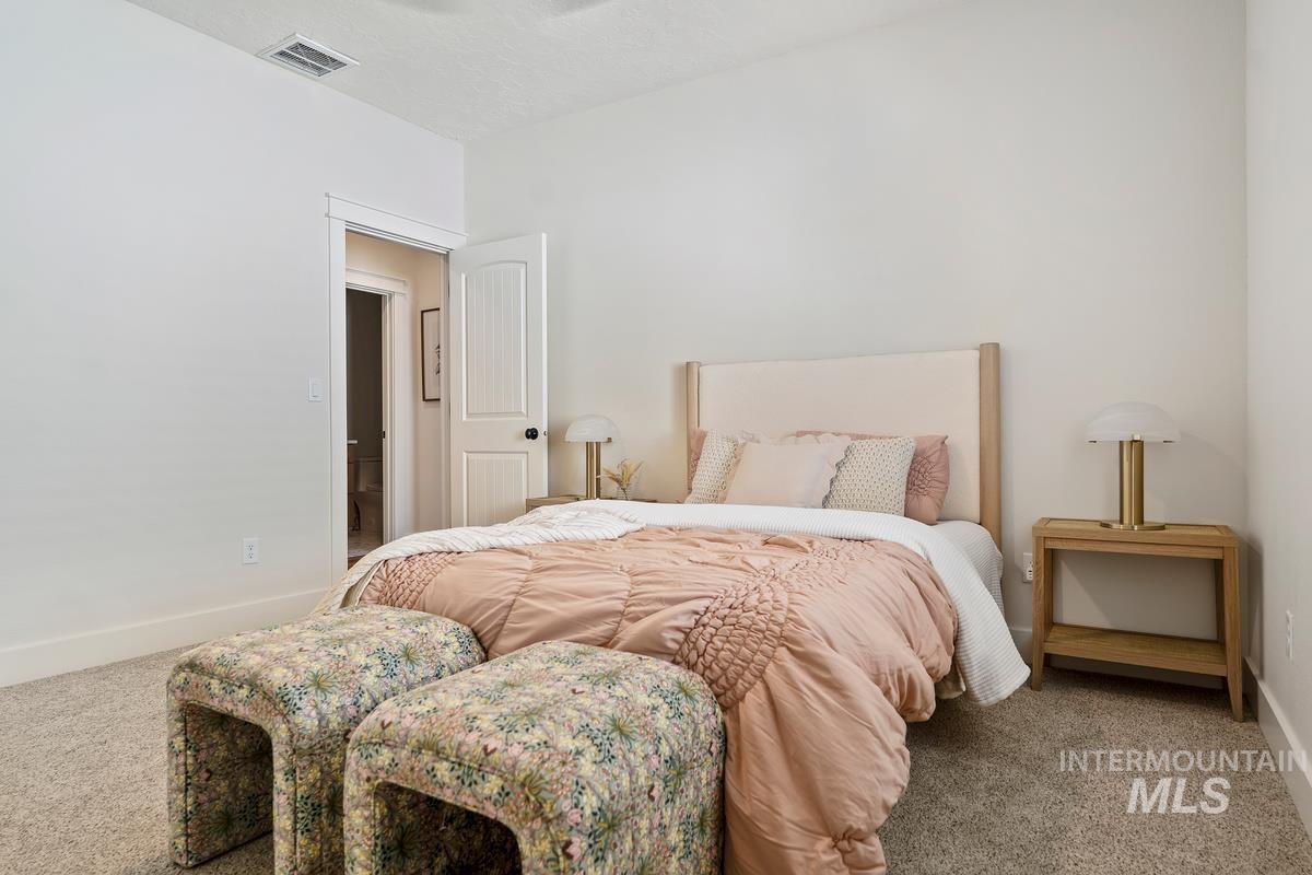 Carpeted bedroom featuring baseboards