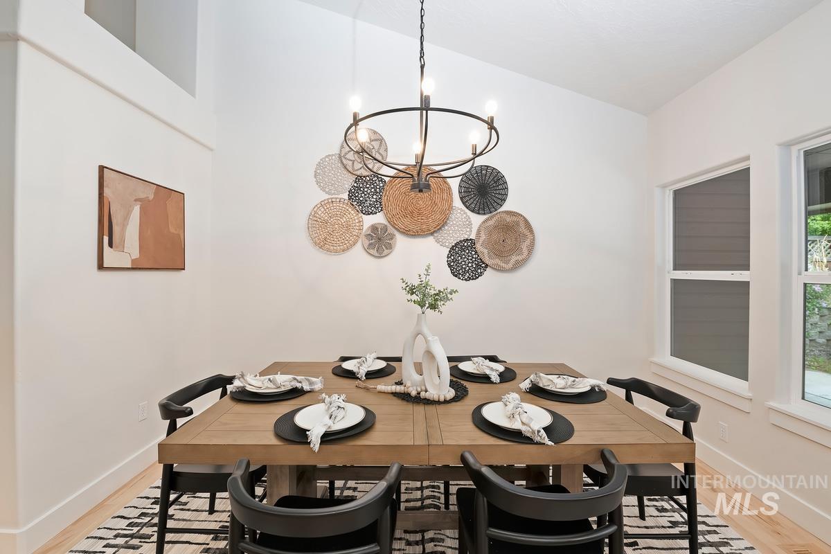Dining room featuring a chandelier and light wood-type flooring