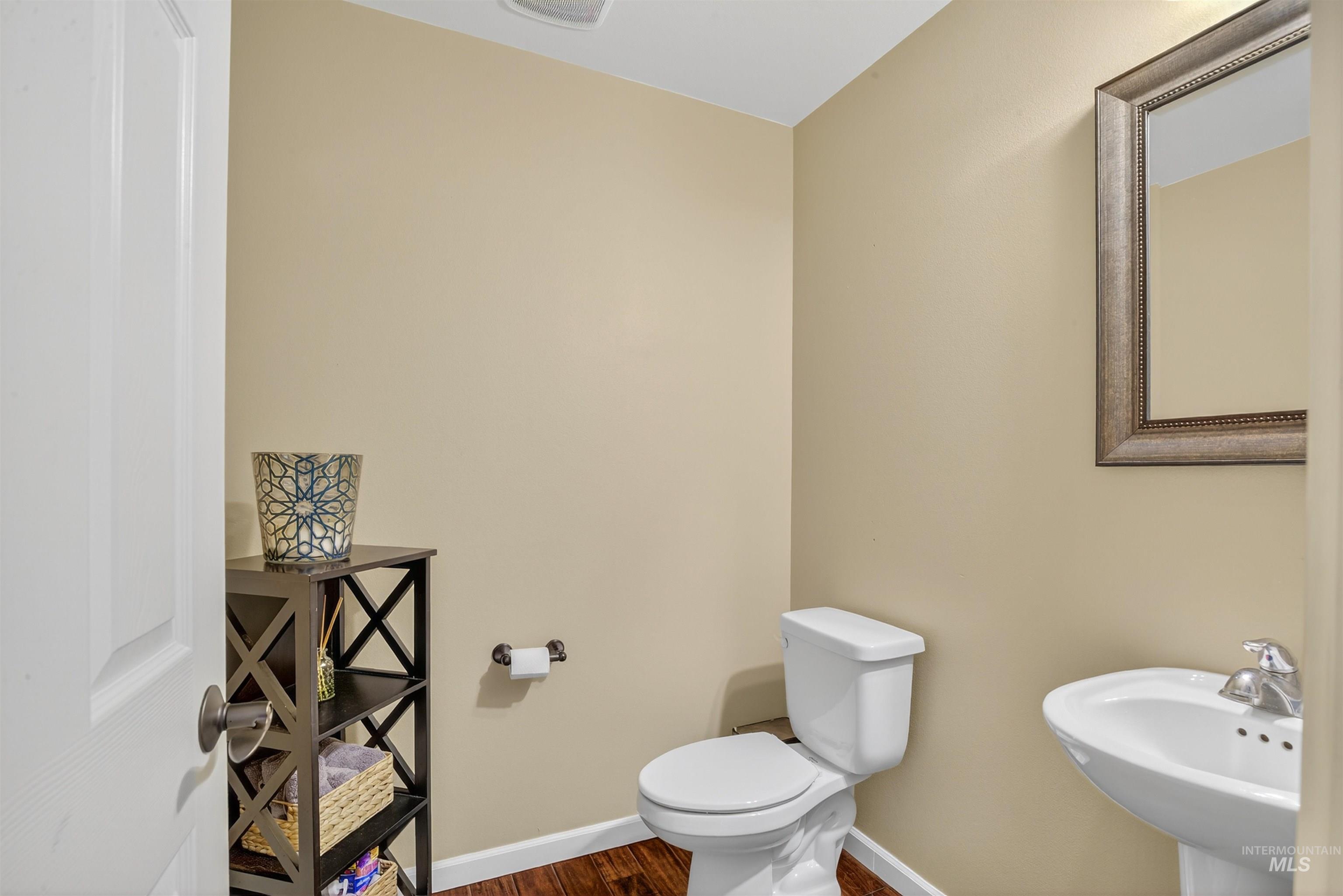 Bathroom with toilet and dark wood-style floors