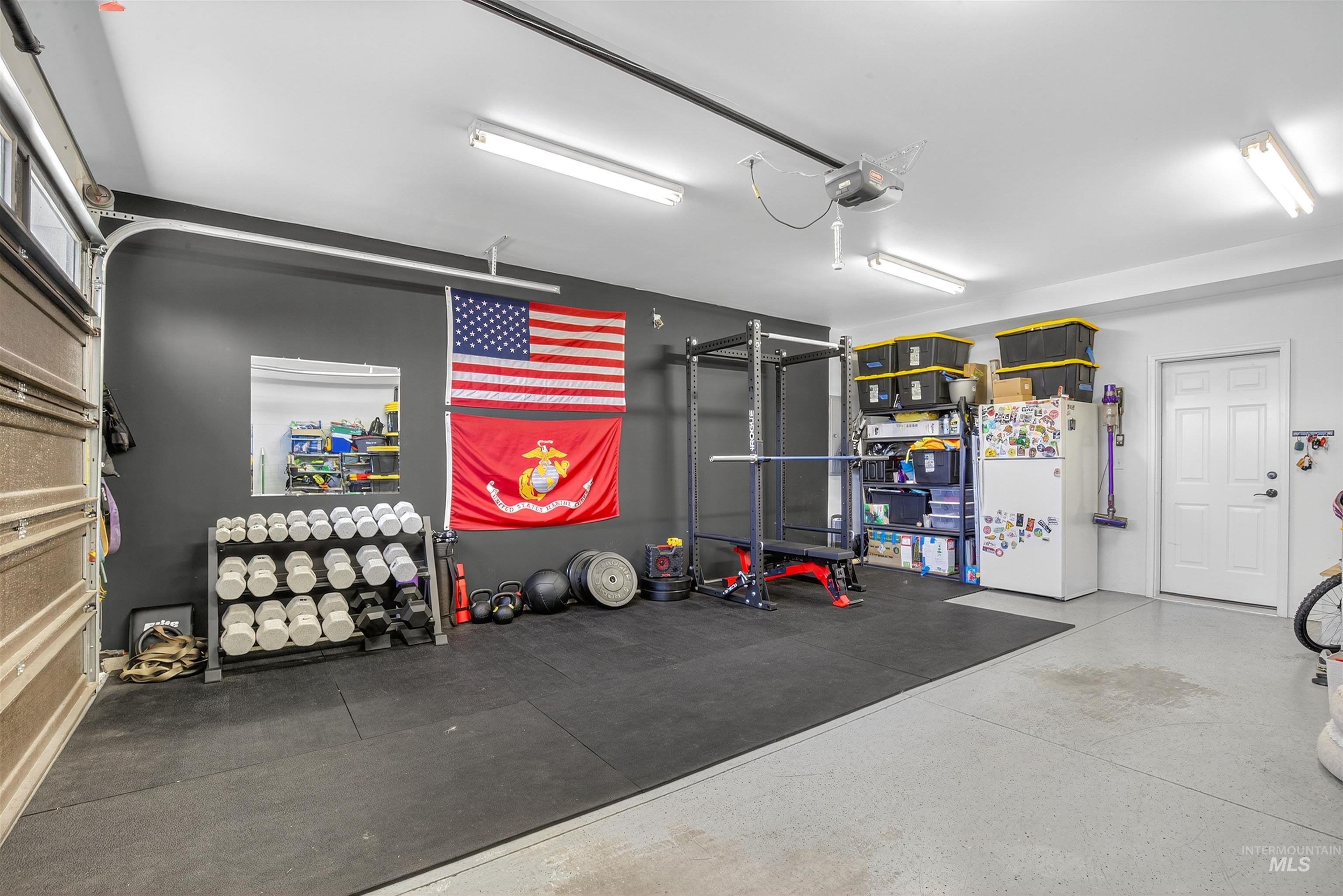 Exercise room featuring a garage