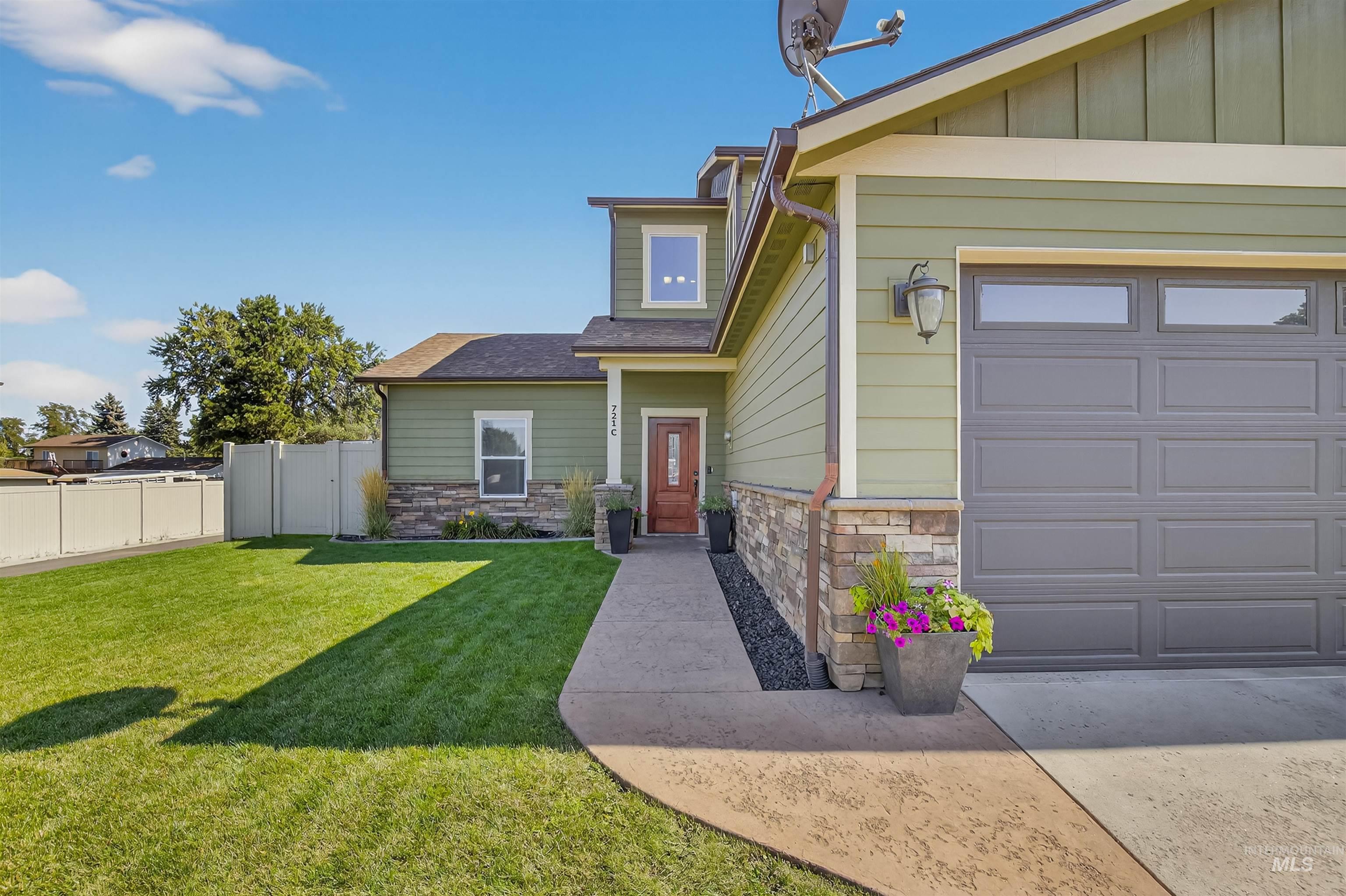 Property entrance featuring stone siding and a garage