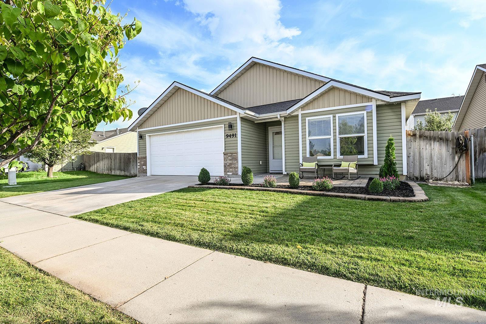 View of front of home featuring driveway, a garage, and board and batten siding