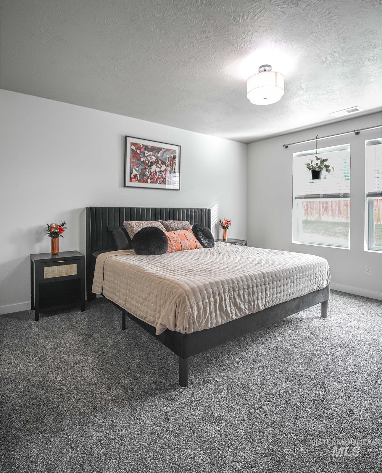 Bedroom with carpet flooring and a textured ceiling