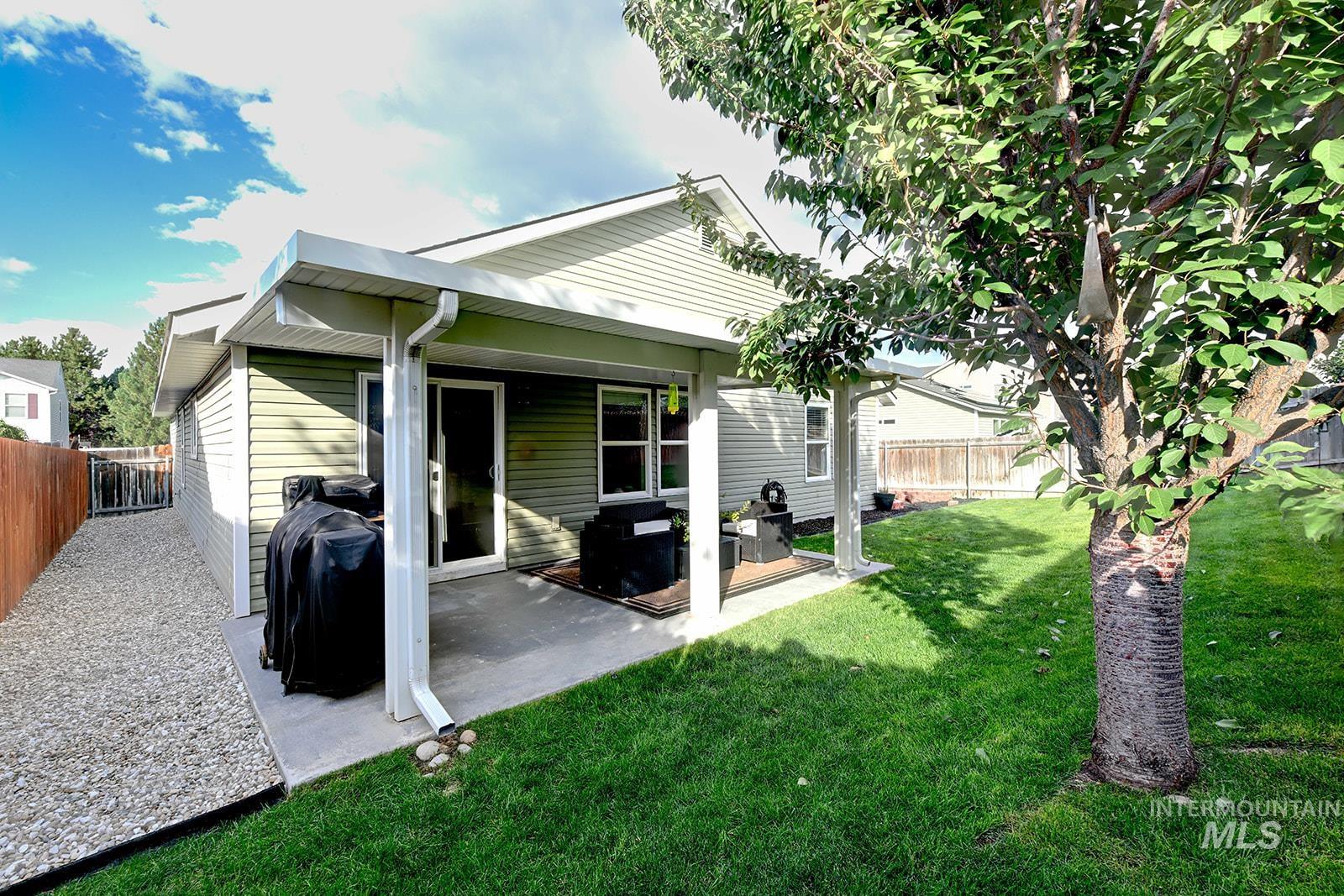 Rear view of property with a patio area and a fenced backyard