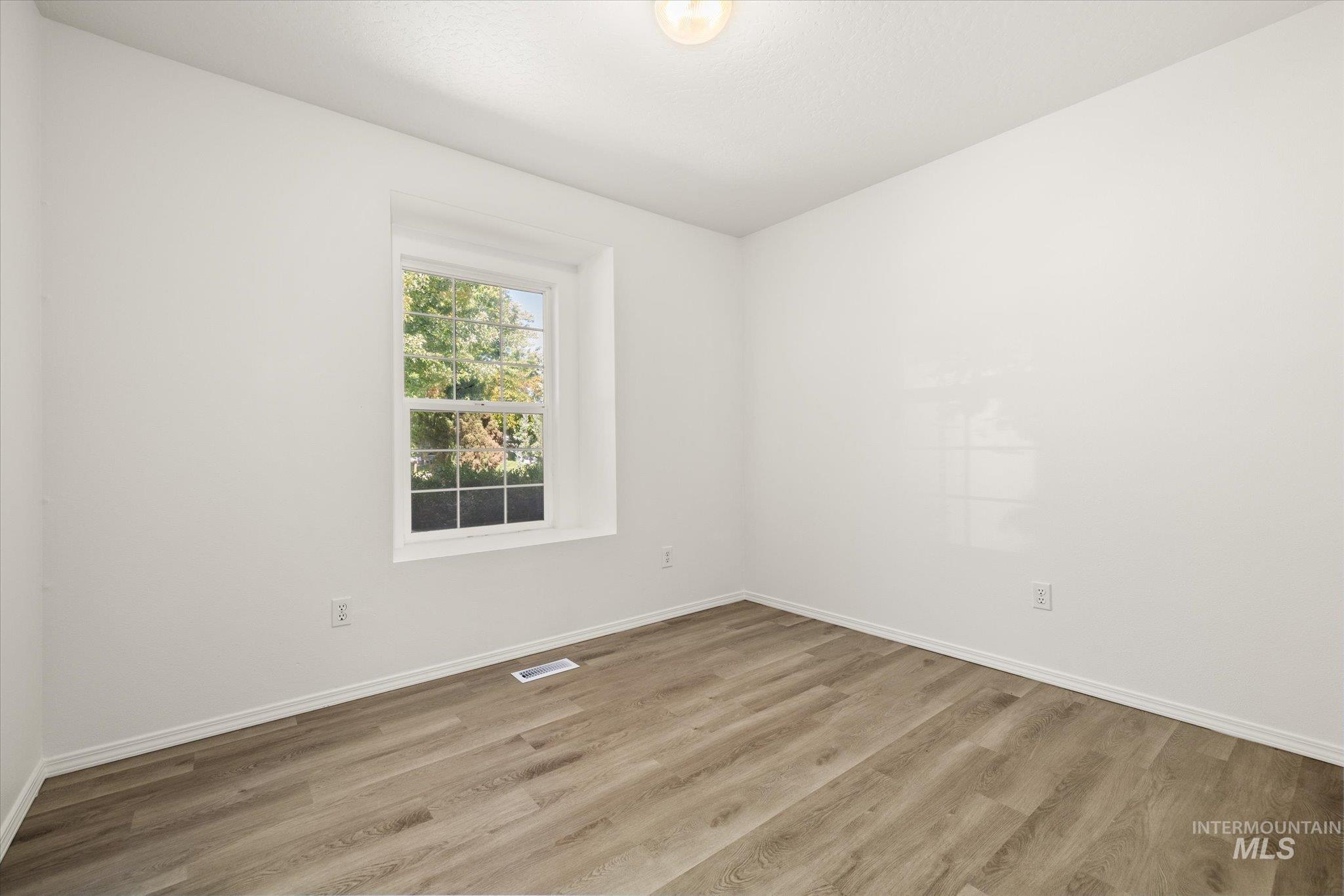 Unfurnished room with wood finished floors