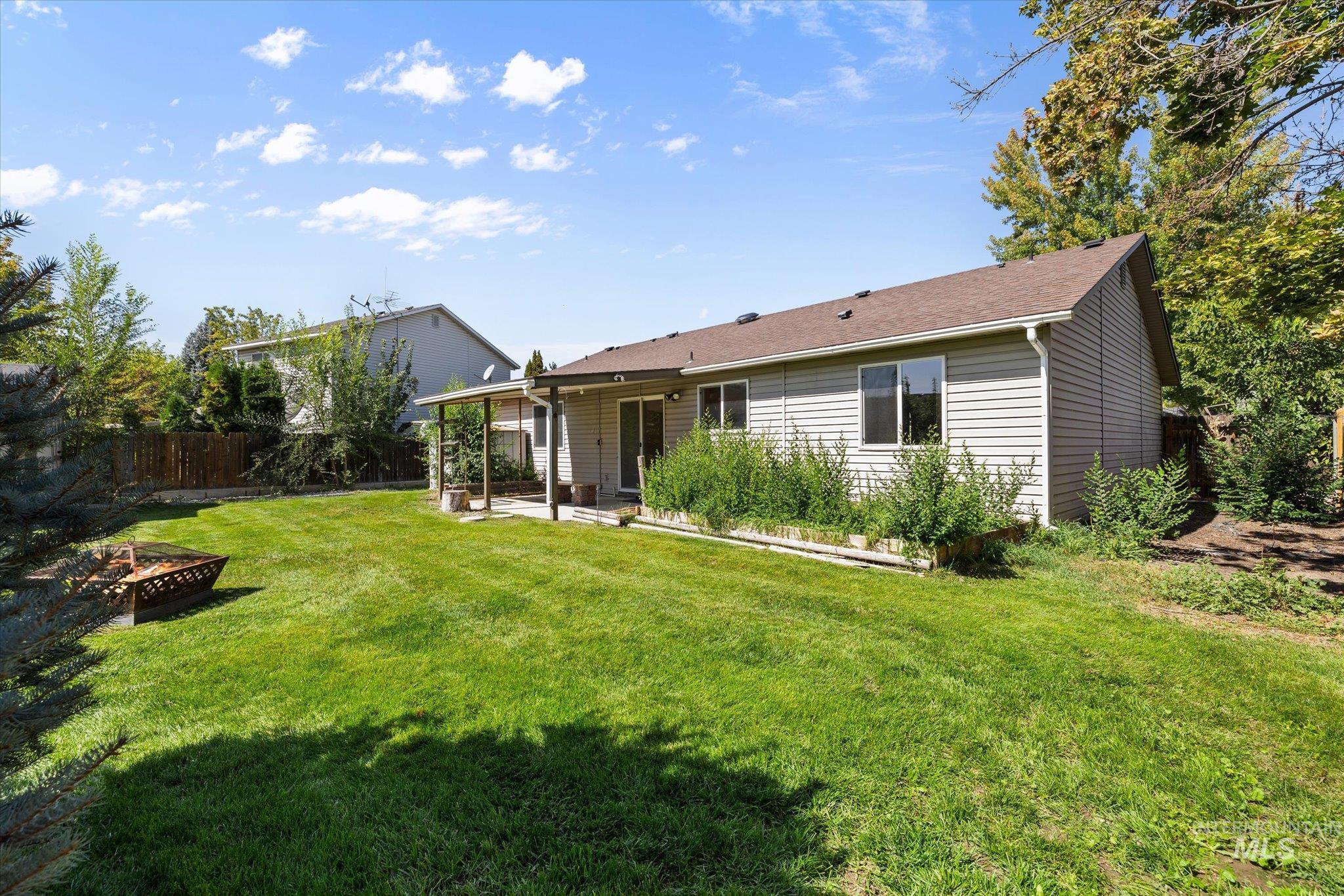 Back of property with a patio area and an outdoor fire pit