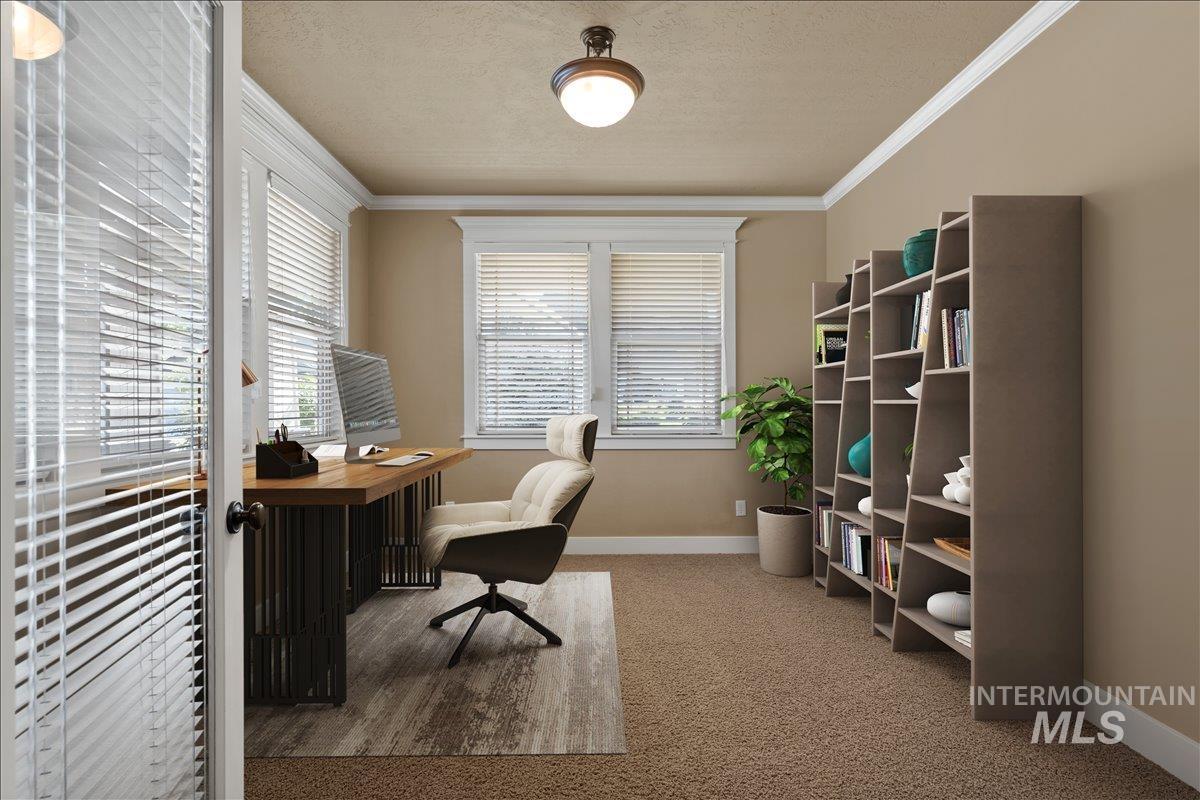 Office area featuring ornamental molding, light carpet, and a textured ceiling
