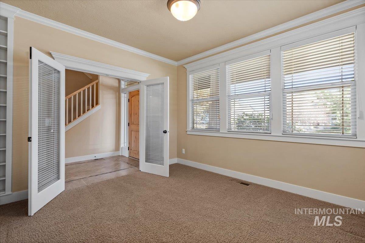 Unfurnished bedroom with carpet and ornamental molding