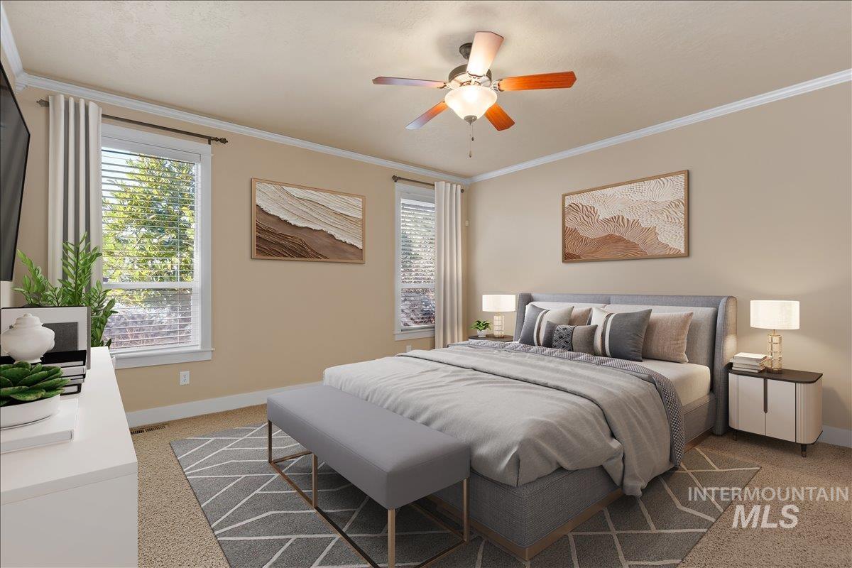 Bedroom with ornamental molding, multiple windows, light carpet, and a ceiling fan