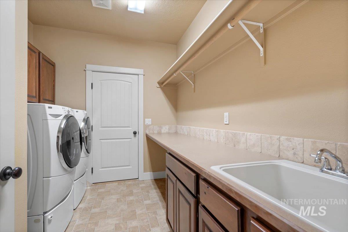 Laundry area featuring cabinet space and washing machine and dryer