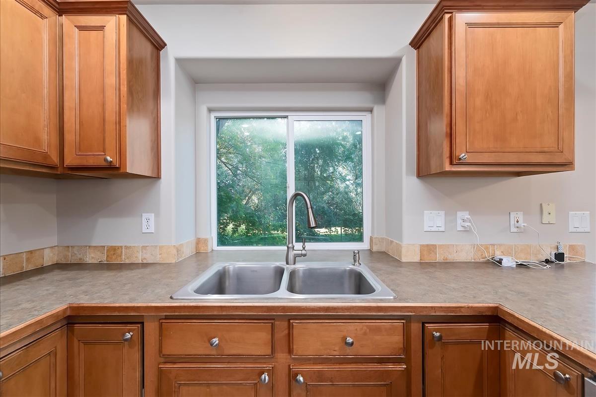 Kitchen with brown cabinets and light countertops