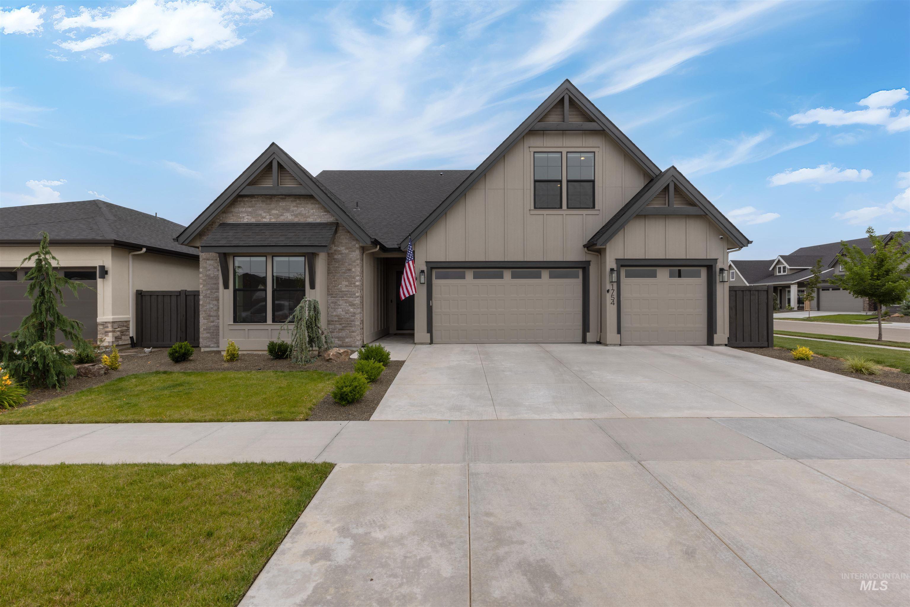 Craftsman-style house with concrete driveway, a garage, a front yard, and board and batten siding