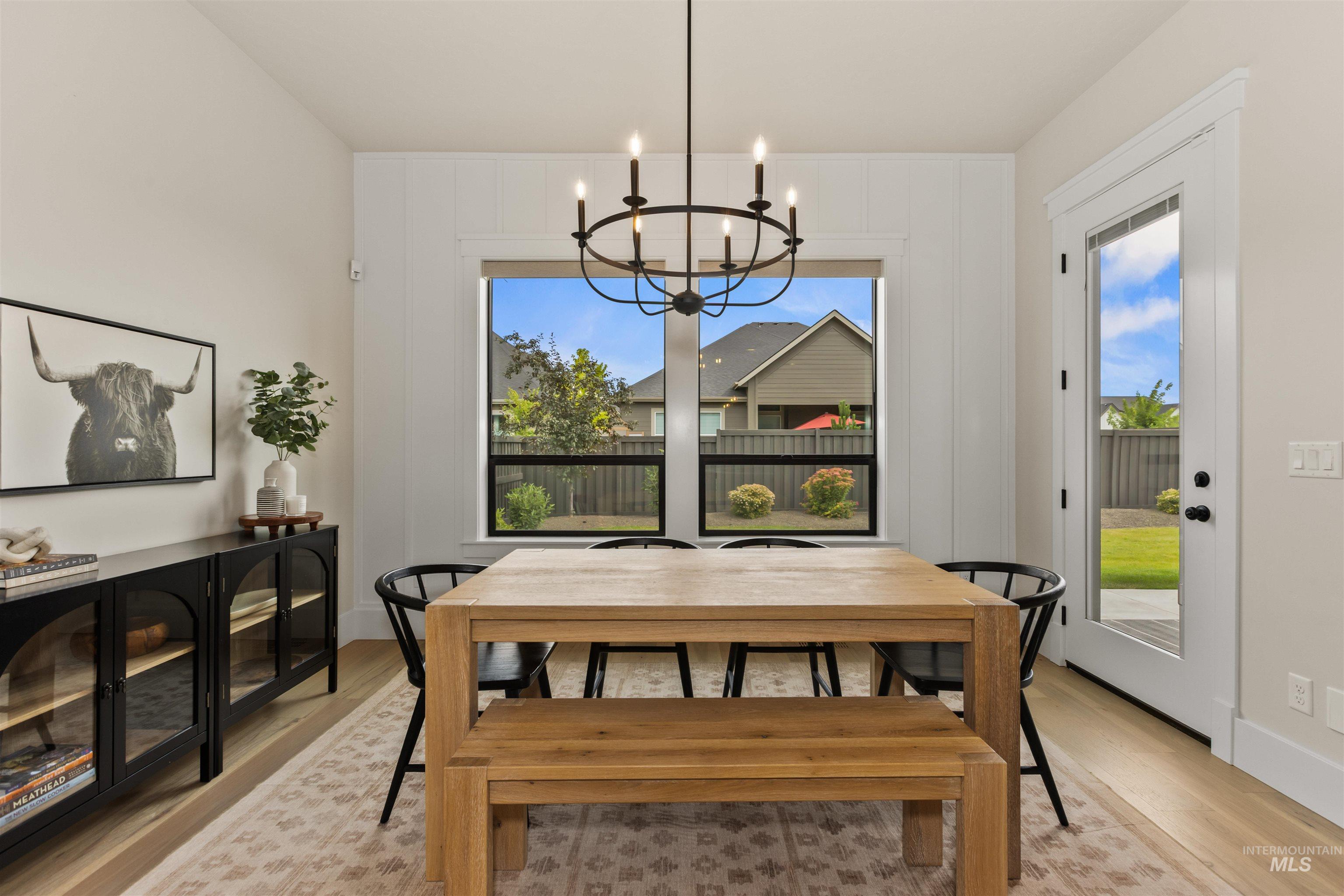 Dining space featuring a chandelier and light wood-type flooring