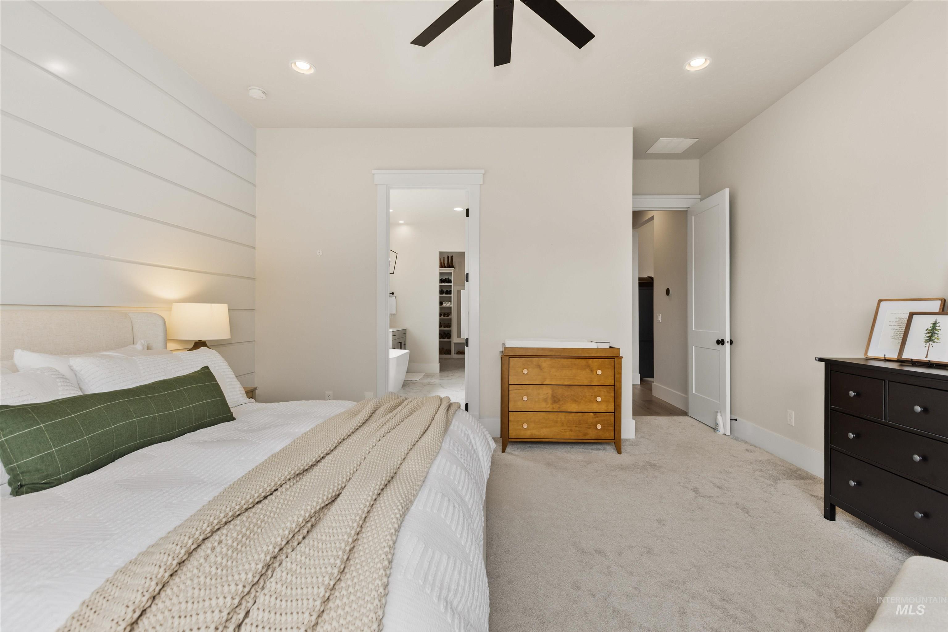 Bedroom featuring light colored carpet, recessed lighting, a ceiling fan, and connected bathroom
