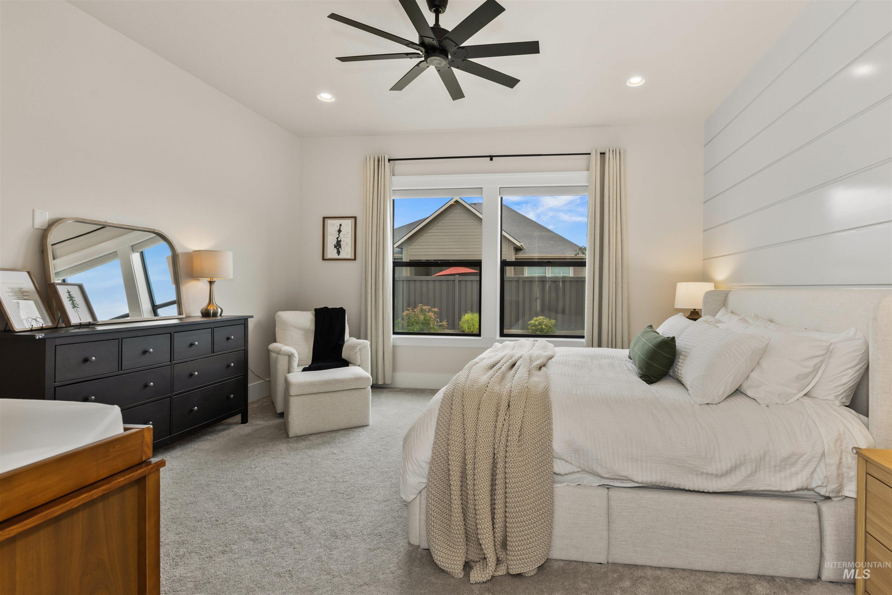 Carpeted bedroom with recessed lighting and ceiling fan