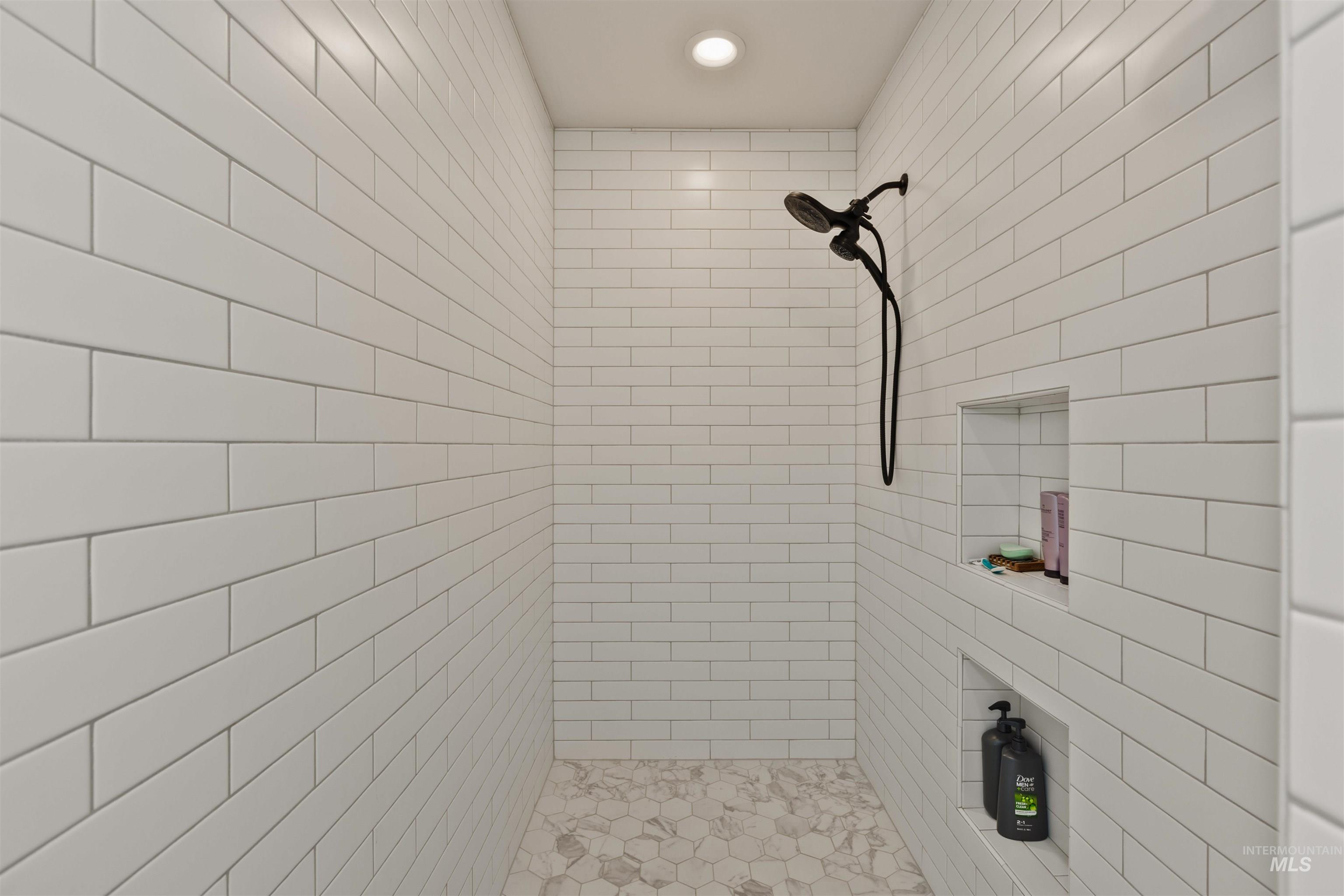 Full bathroom with tiled shower and recessed lighting