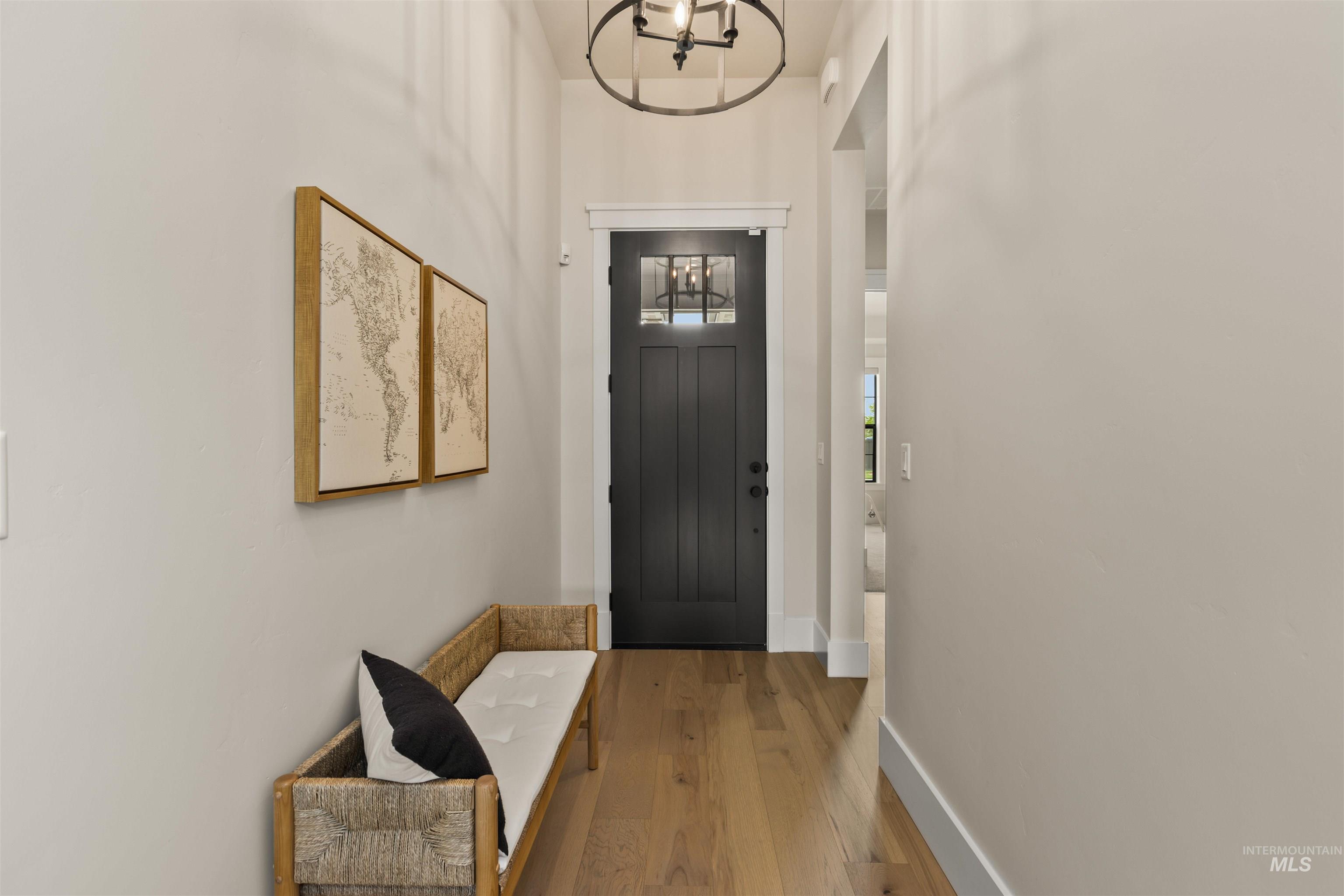 Foyer featuring hardwood / wood-style floors and a chandelier