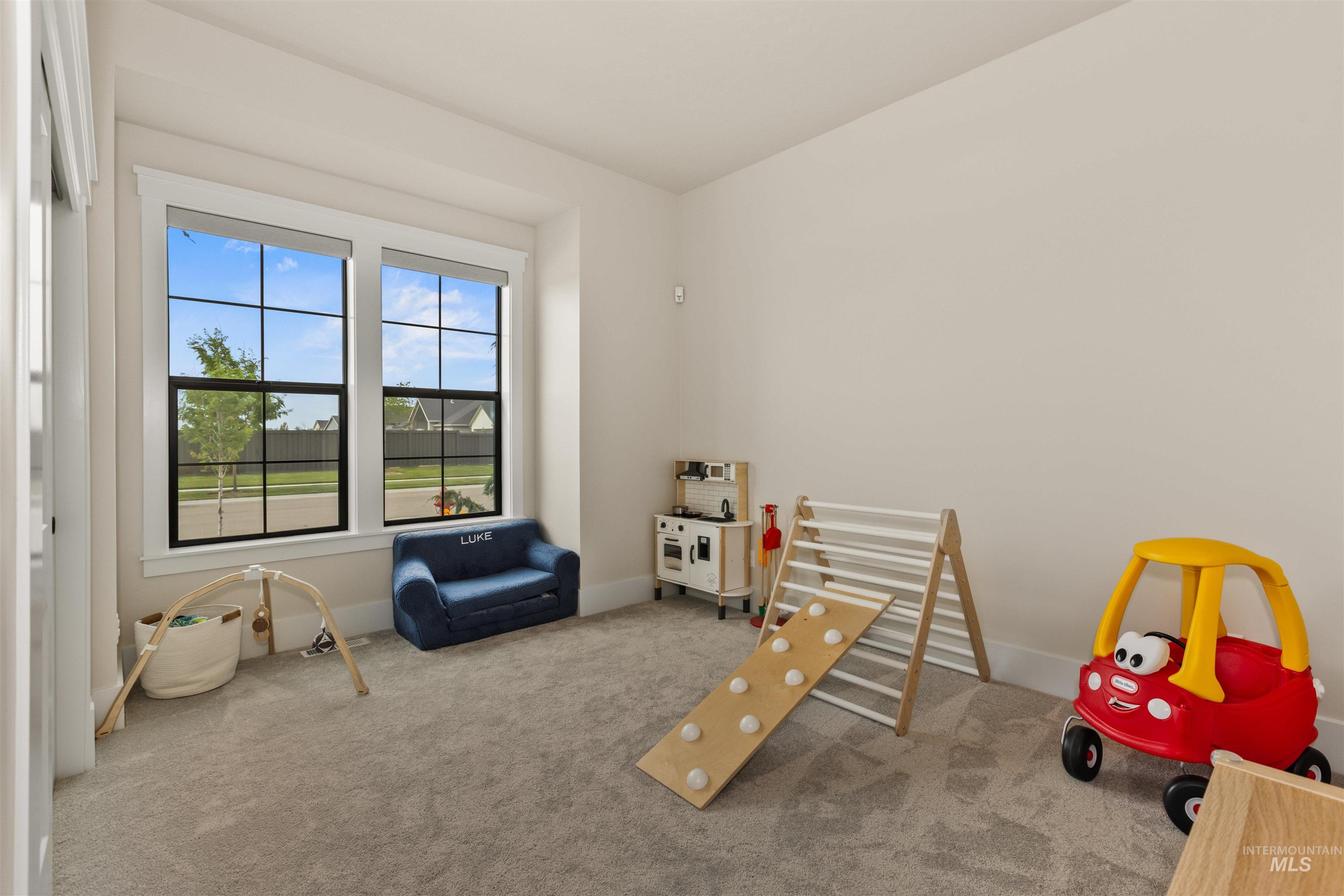 Rec room featuring carpet and baseboards