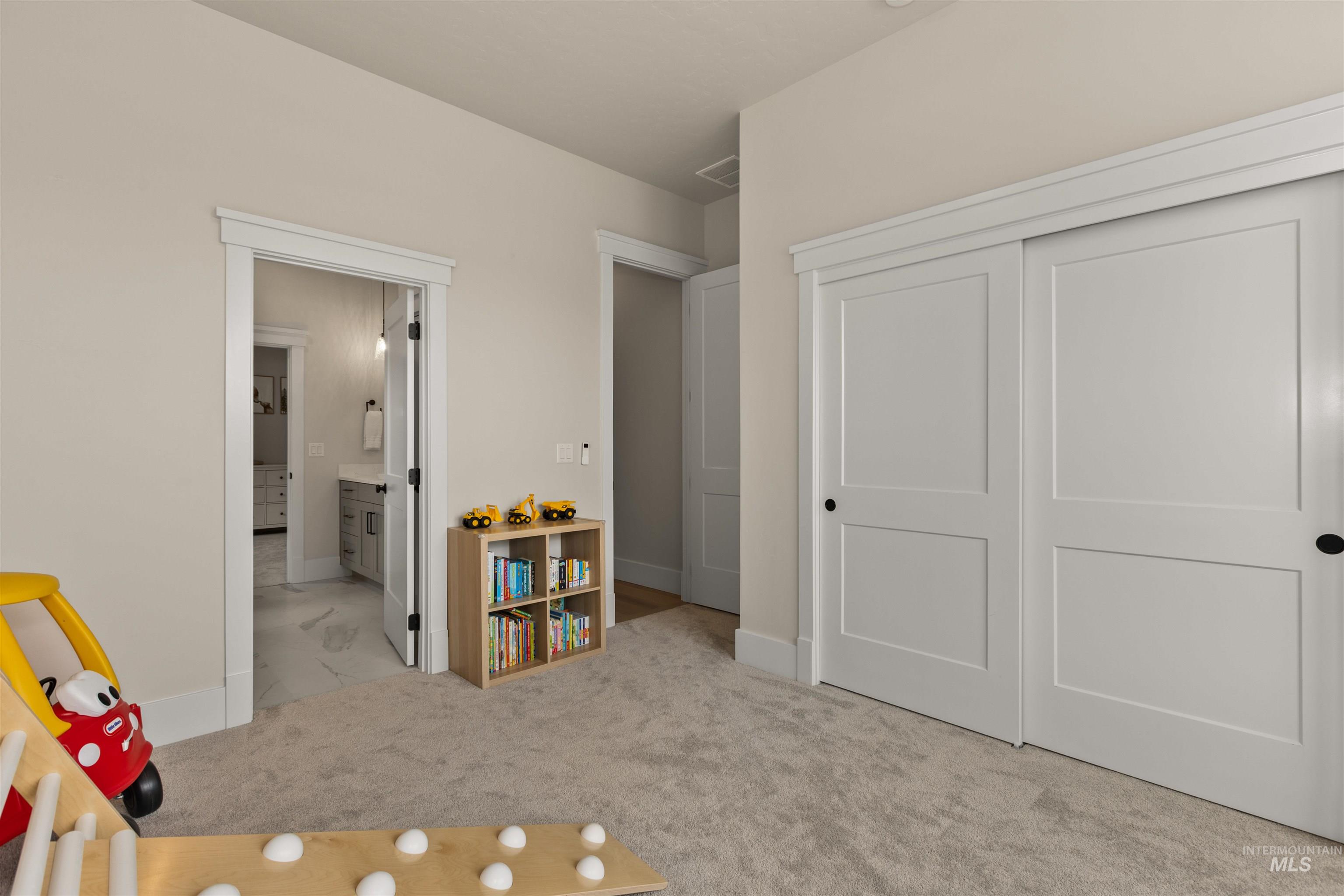 Bedroom featuring a closet, connected bathroom, and carpet