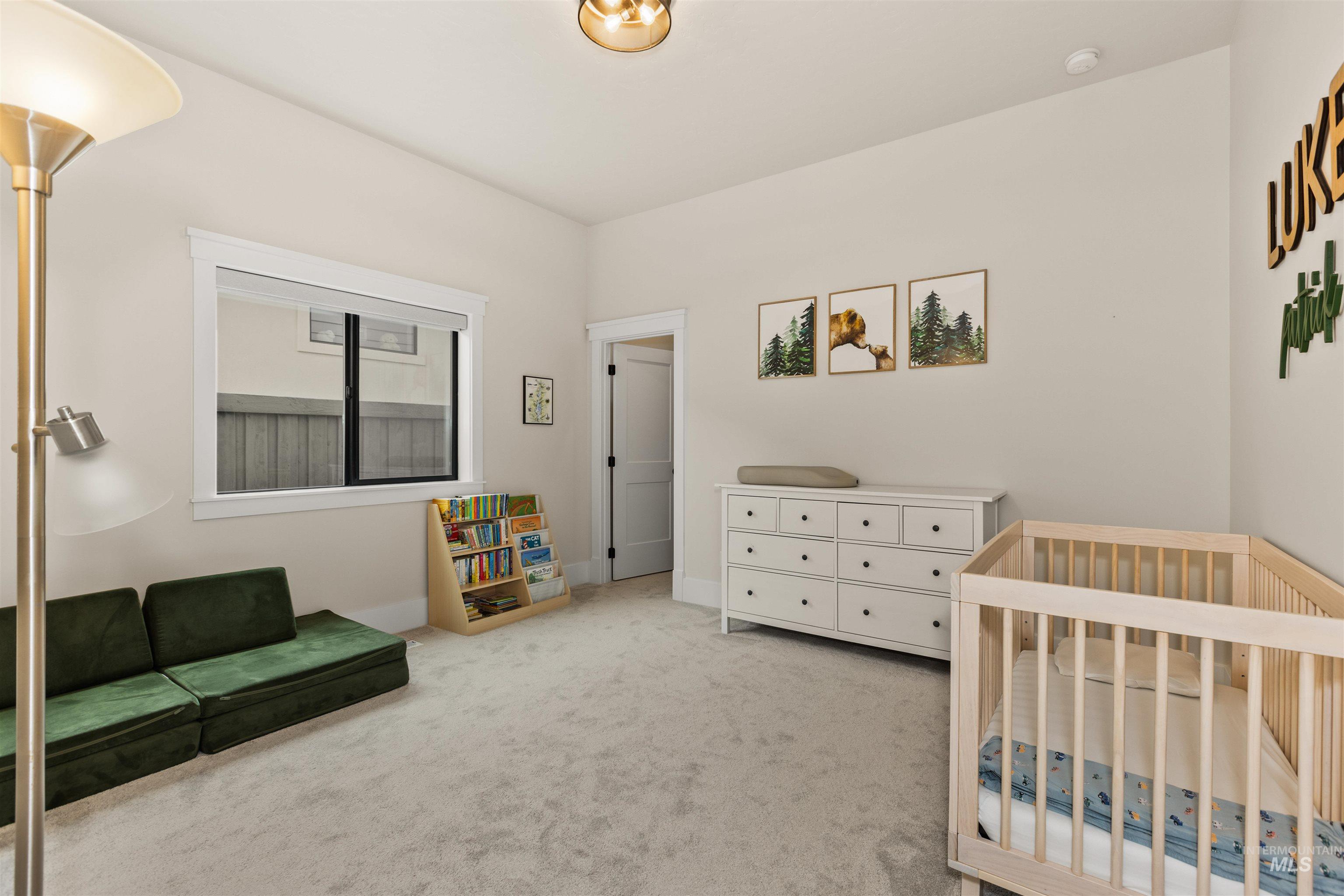 Bedroom with light carpet and baseboards