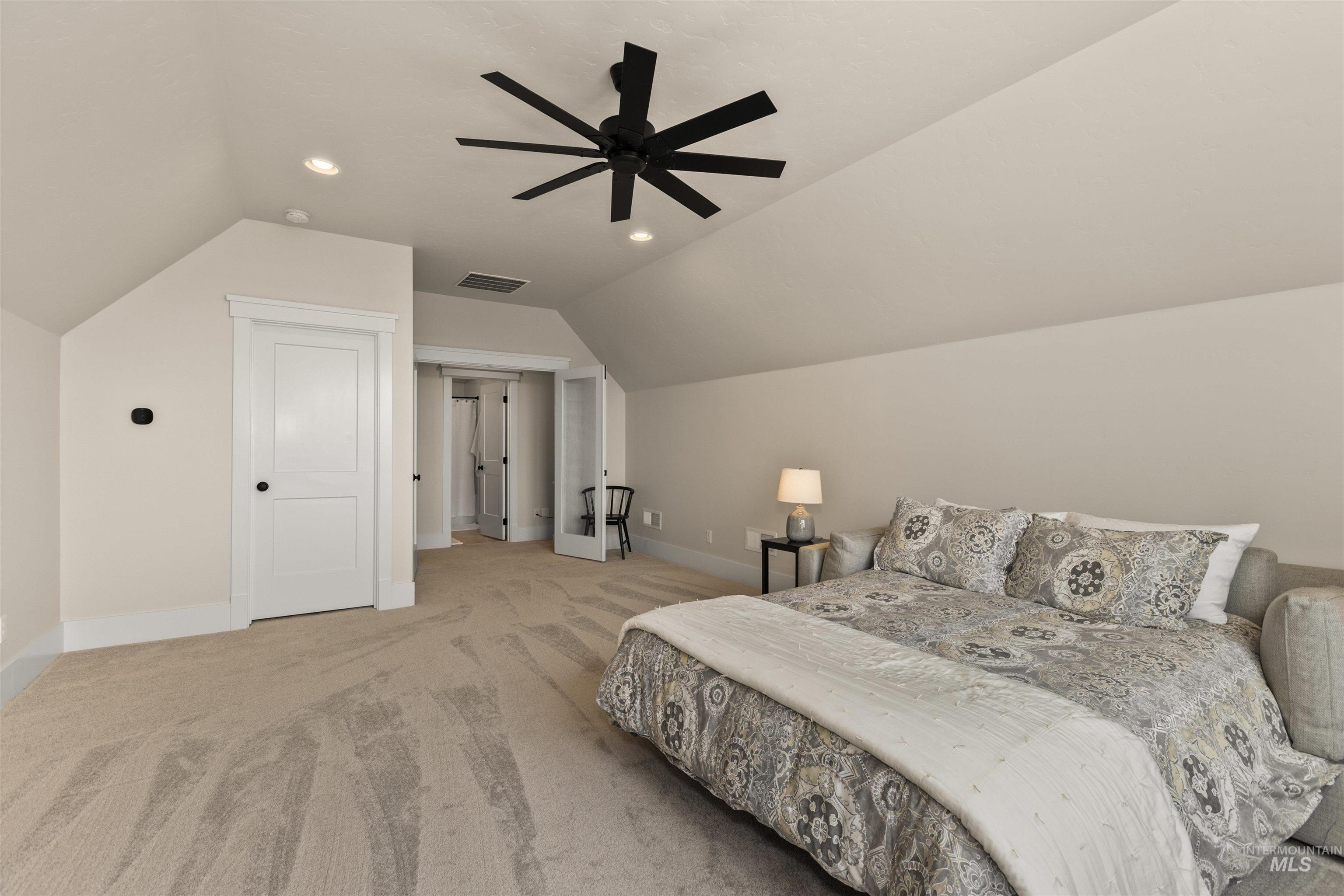 Bedroom with vaulted ceiling, carpet flooring, recessed lighting, and ceiling fan